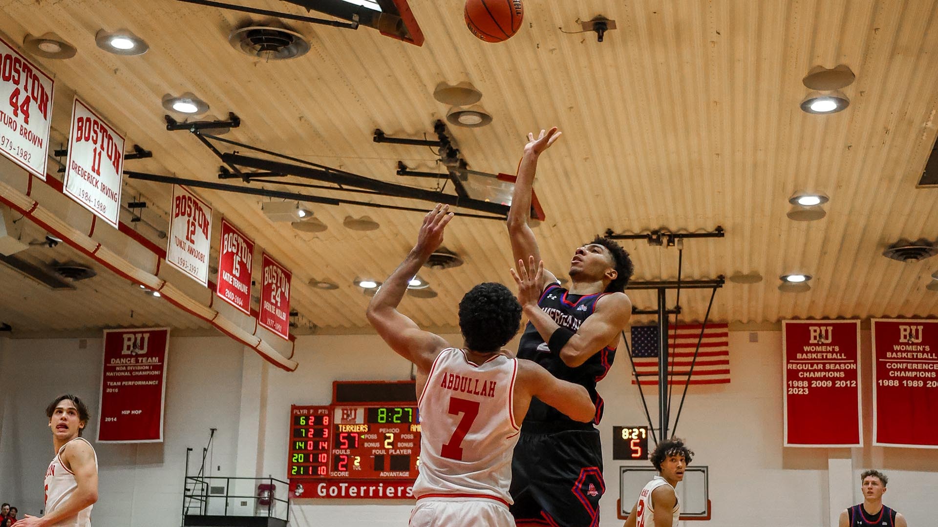 Madden Collins taking a shot for men's basketball in a game at BU