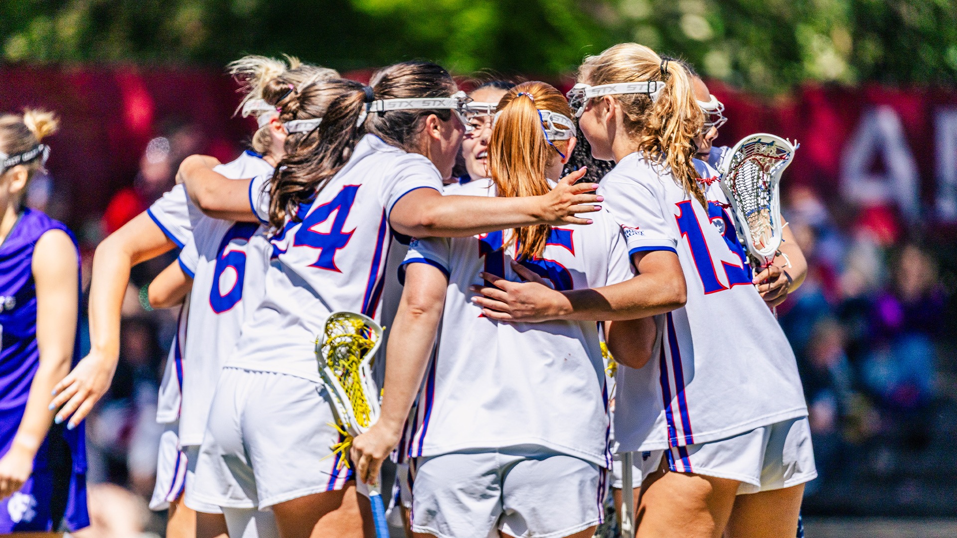 The lacrosse team in a huddle.