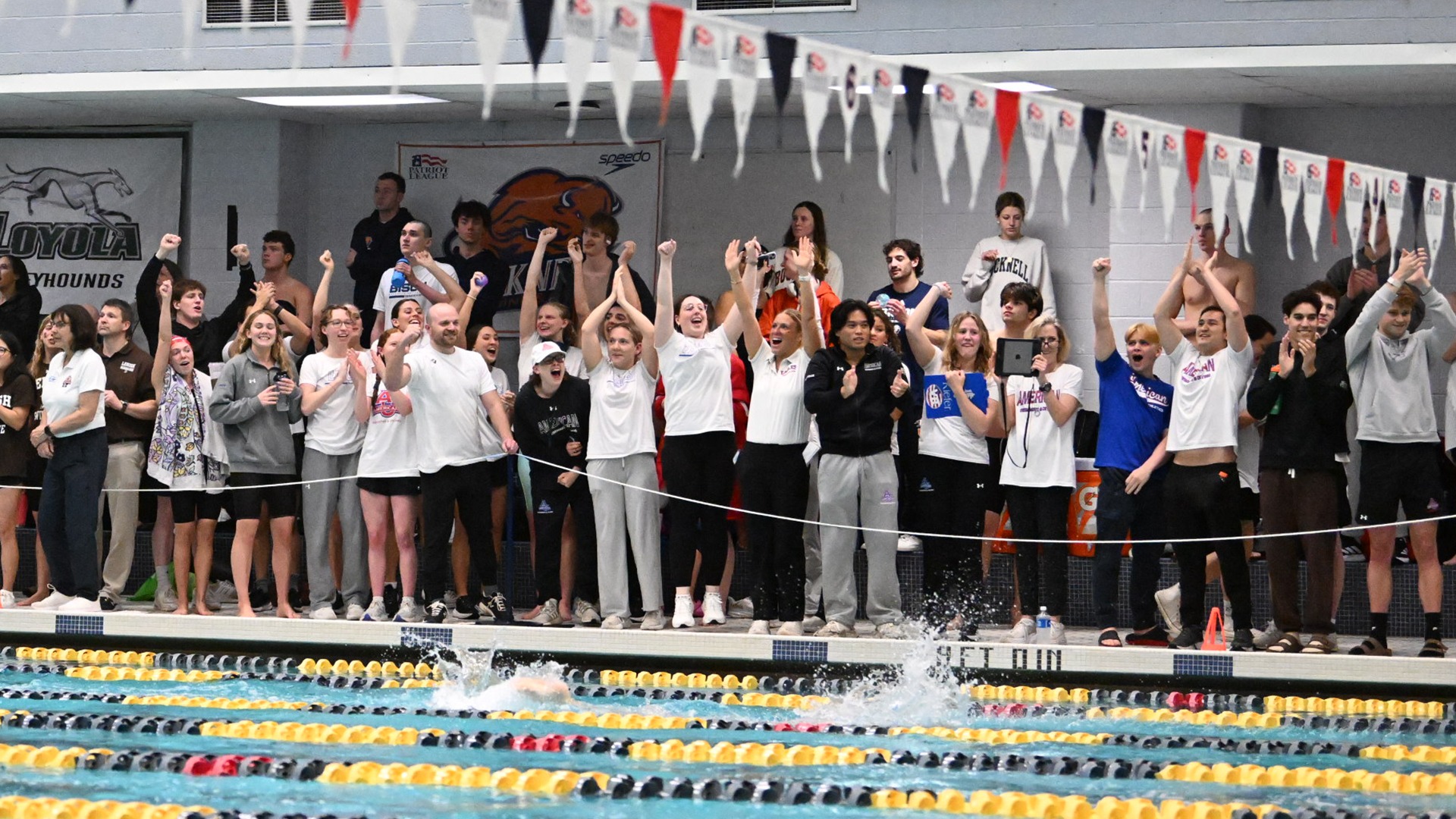 swim and dive team cheering on the pool deck during the 2026 Patriot League Championships at Navy