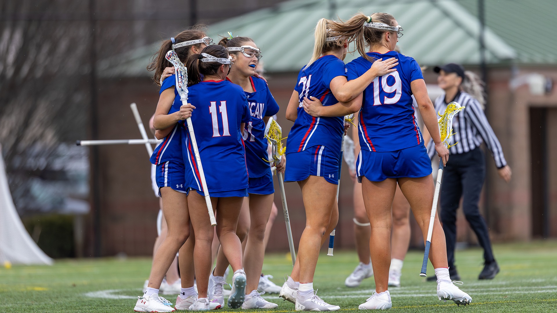 The lacrosse team celebrating a goal.