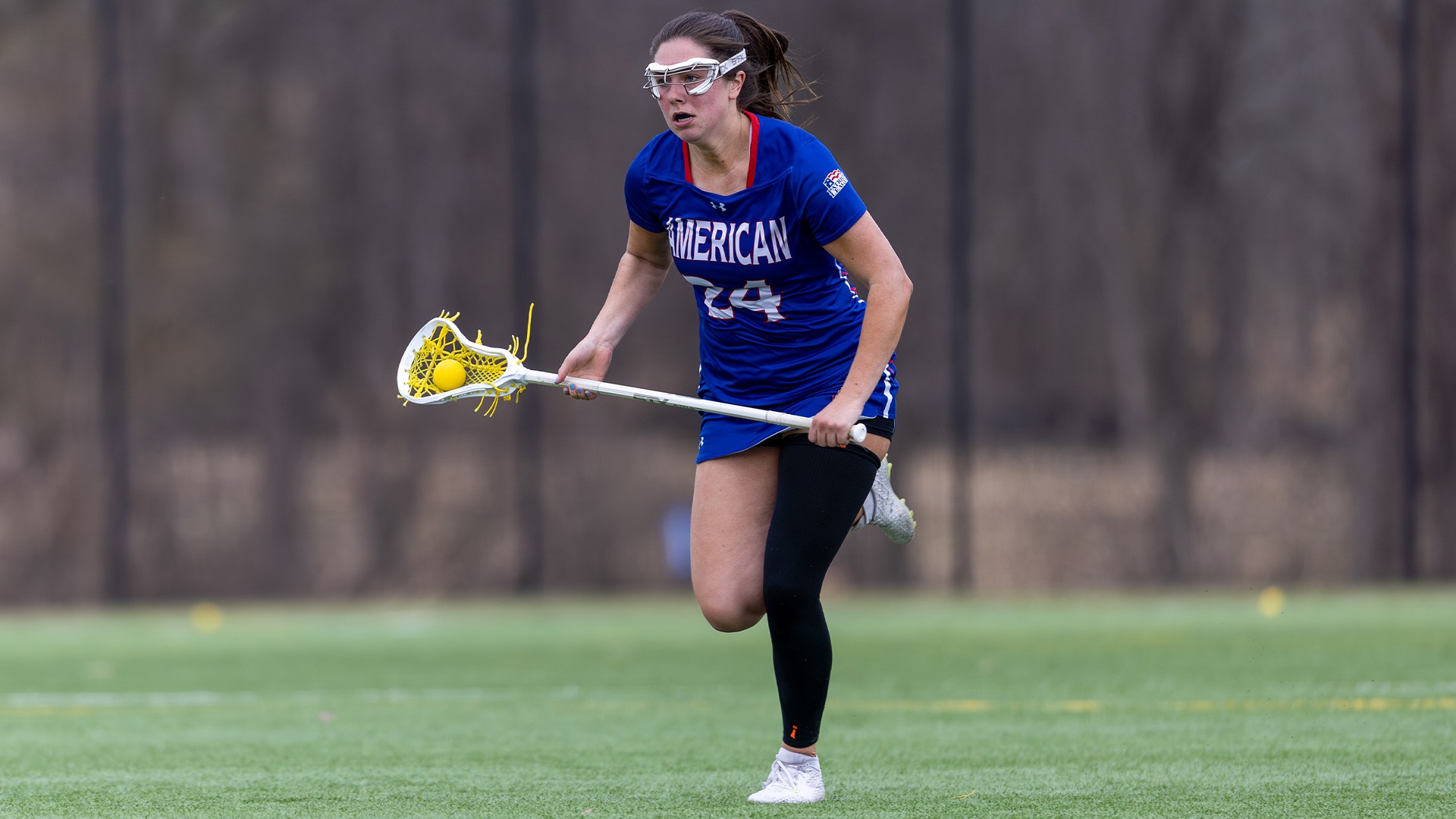 Reagan Murdoch carrying the ball in a lacrosse game at Lehigh. 