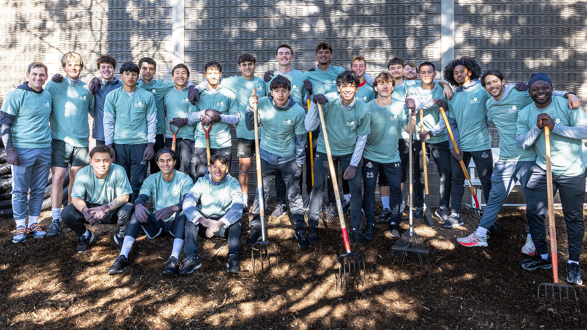 the men's soccer team posing for a group photo while helping out at Campus Beautification Day in 2026