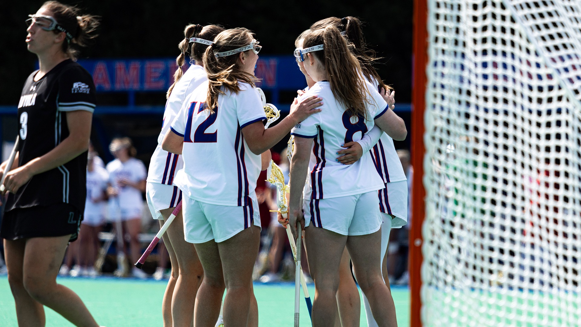 The lacrosse team celebrating a goal.
