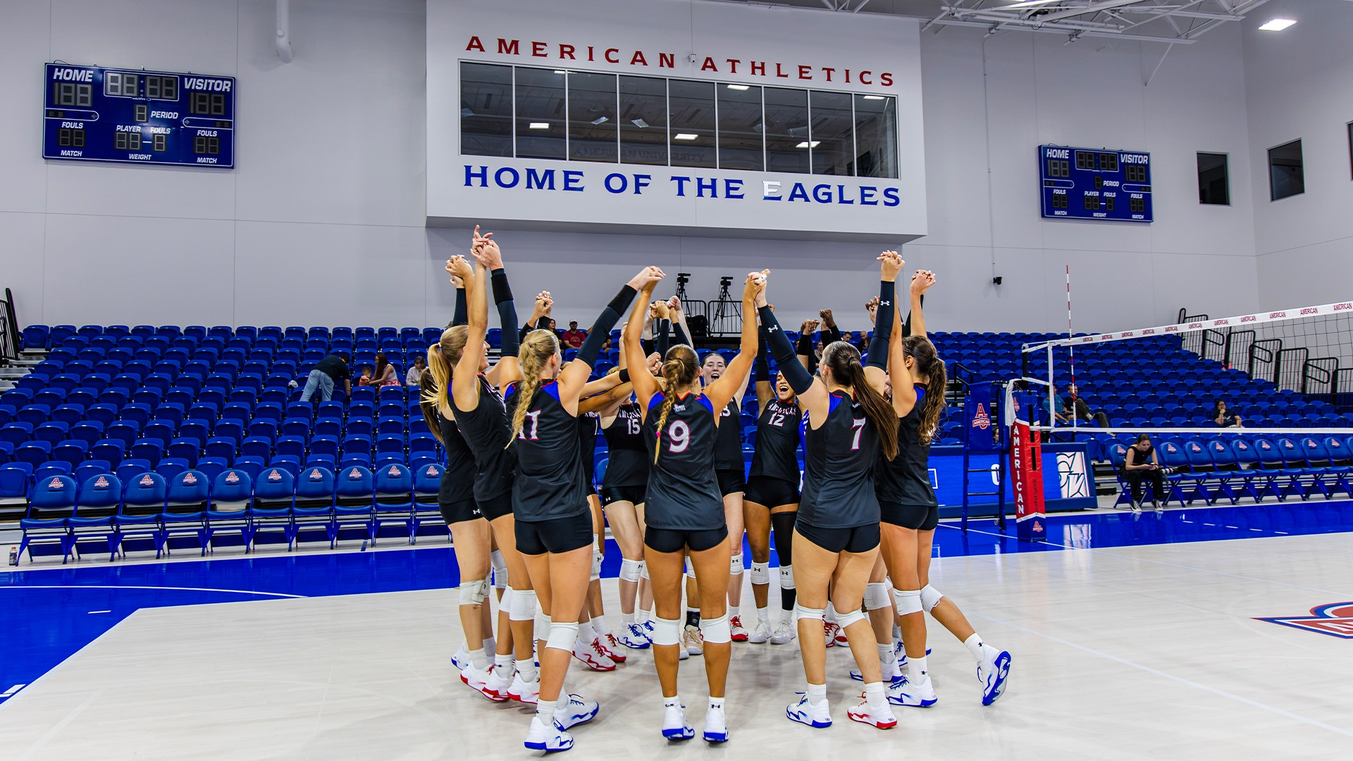 The volleyball team in the Meltzer Center on Barry Goldberg Court in a huddle. 