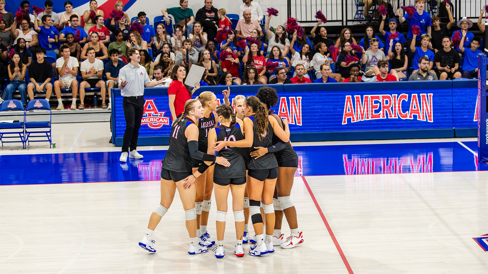 The volleyball in a huddle in a match against Georgetown. 