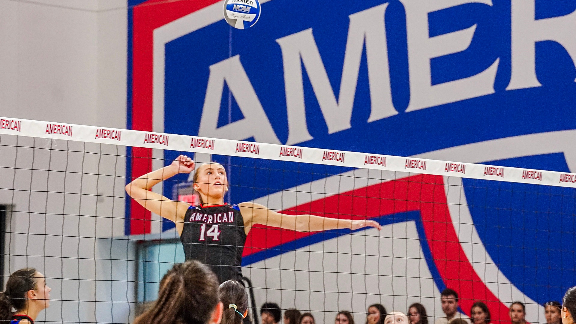 Elise Sterling hitting the ball in a volleyball match against Georgetown