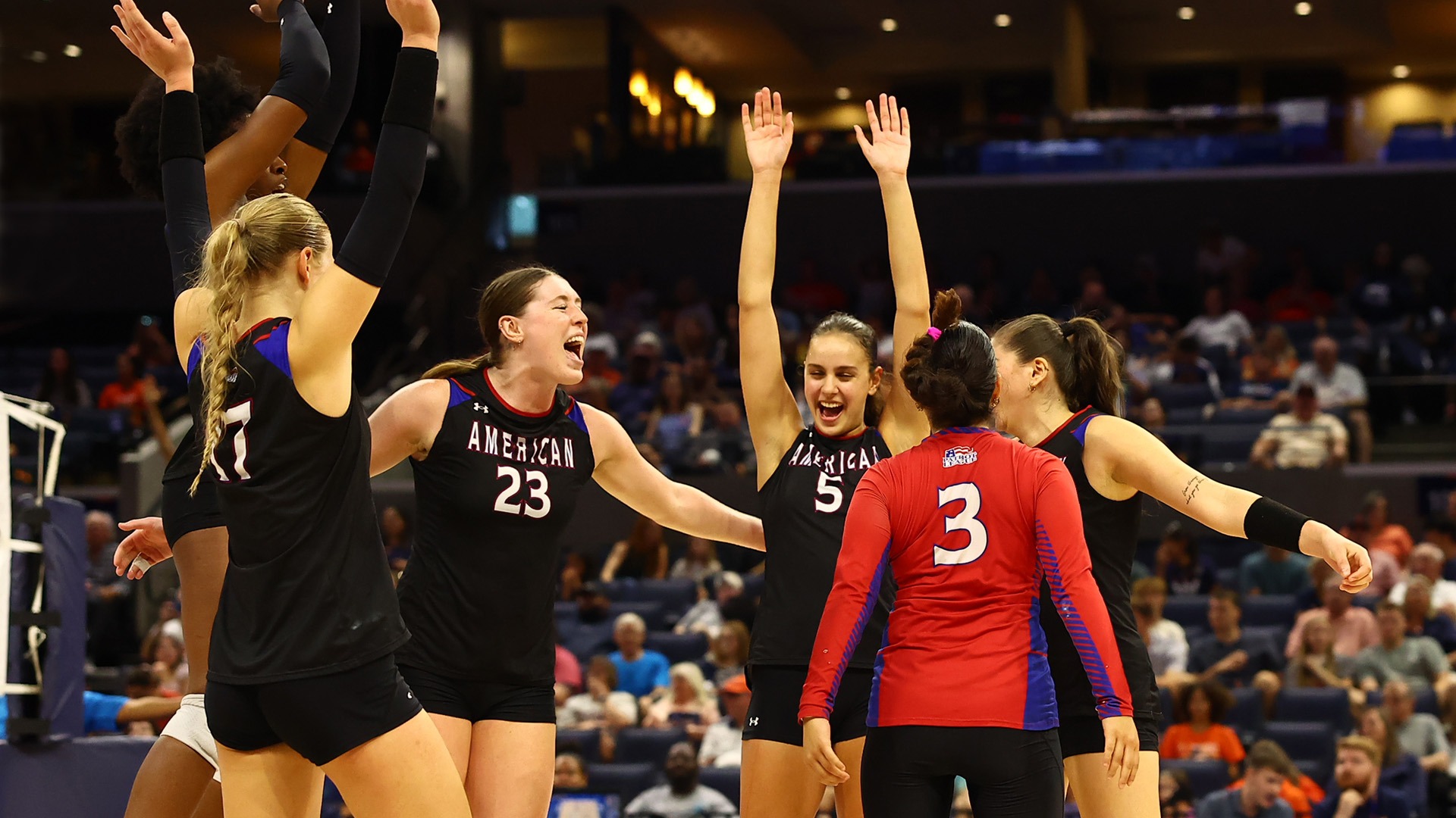 volleyball team celebrating a win at Virginia