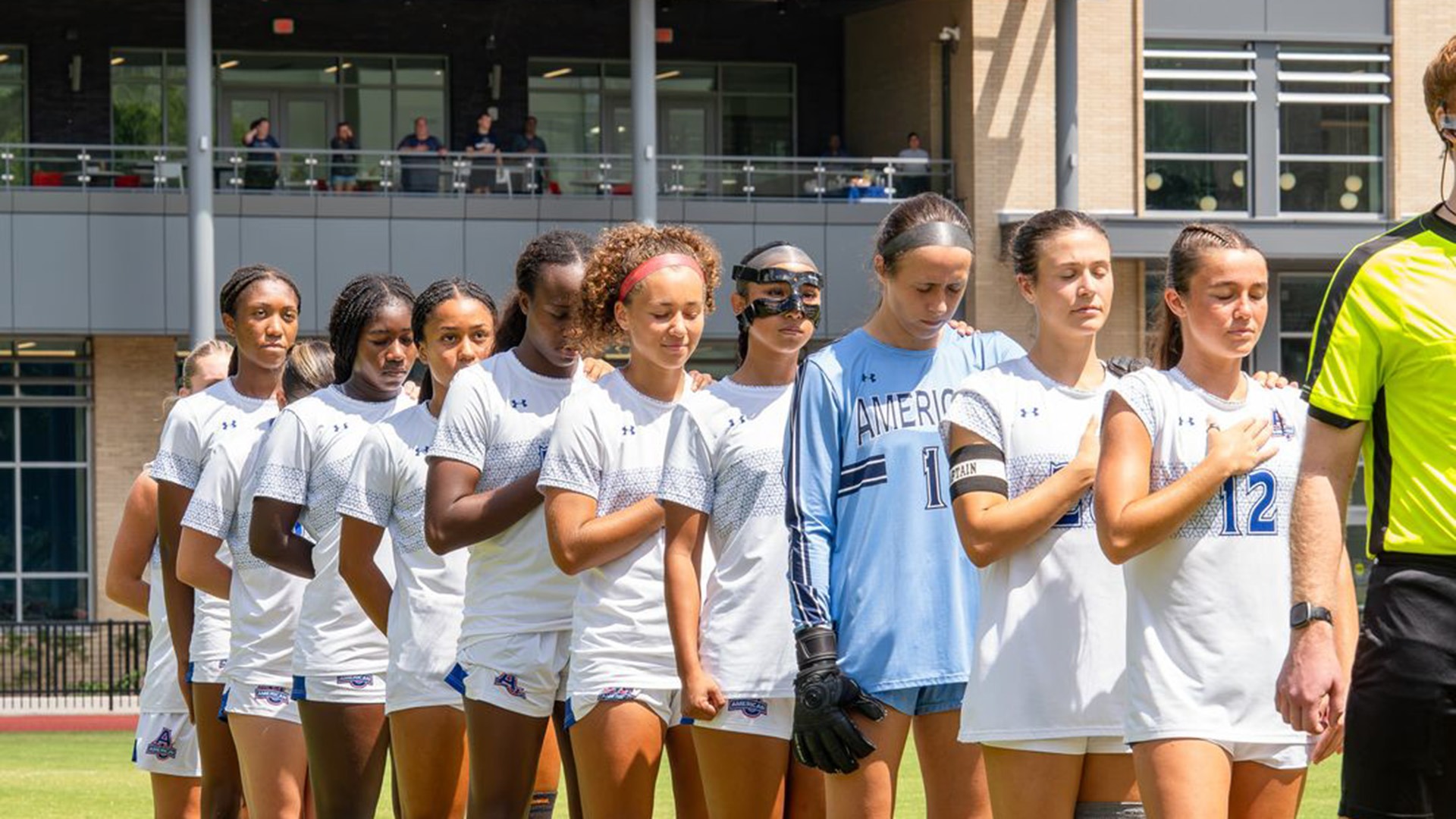 women's soccer players during the national anthem