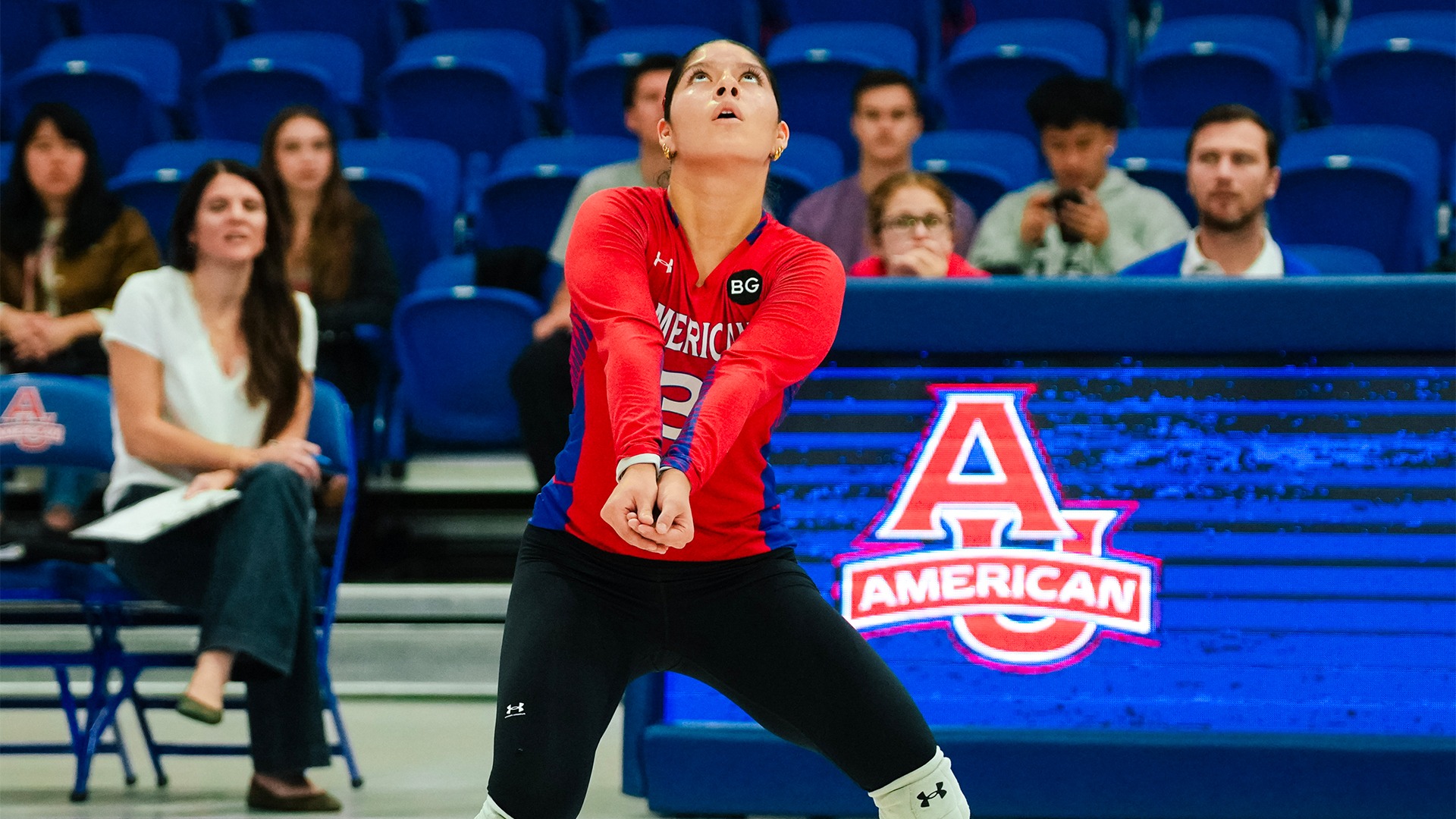 Bella Marrero bumping a ball in a volleyball match. 