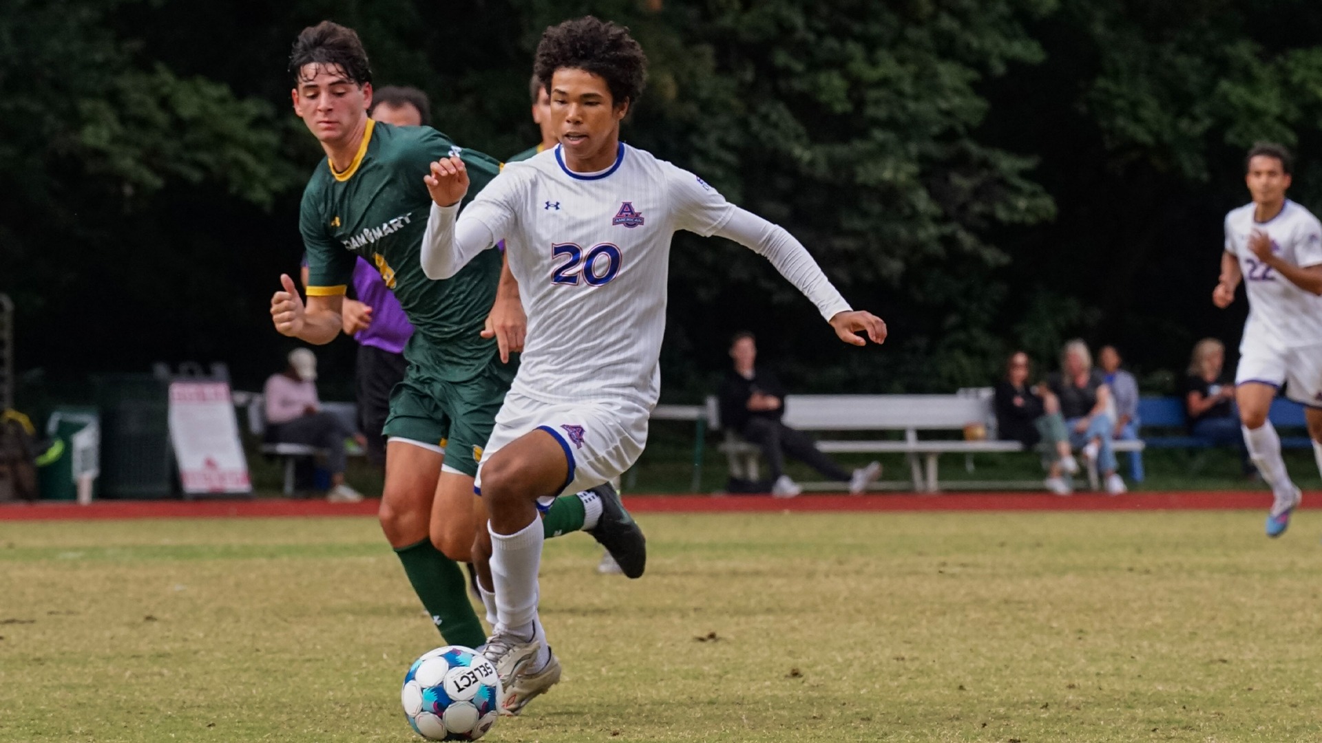 Yuta Phoenix dribbling in a soccer match. 
