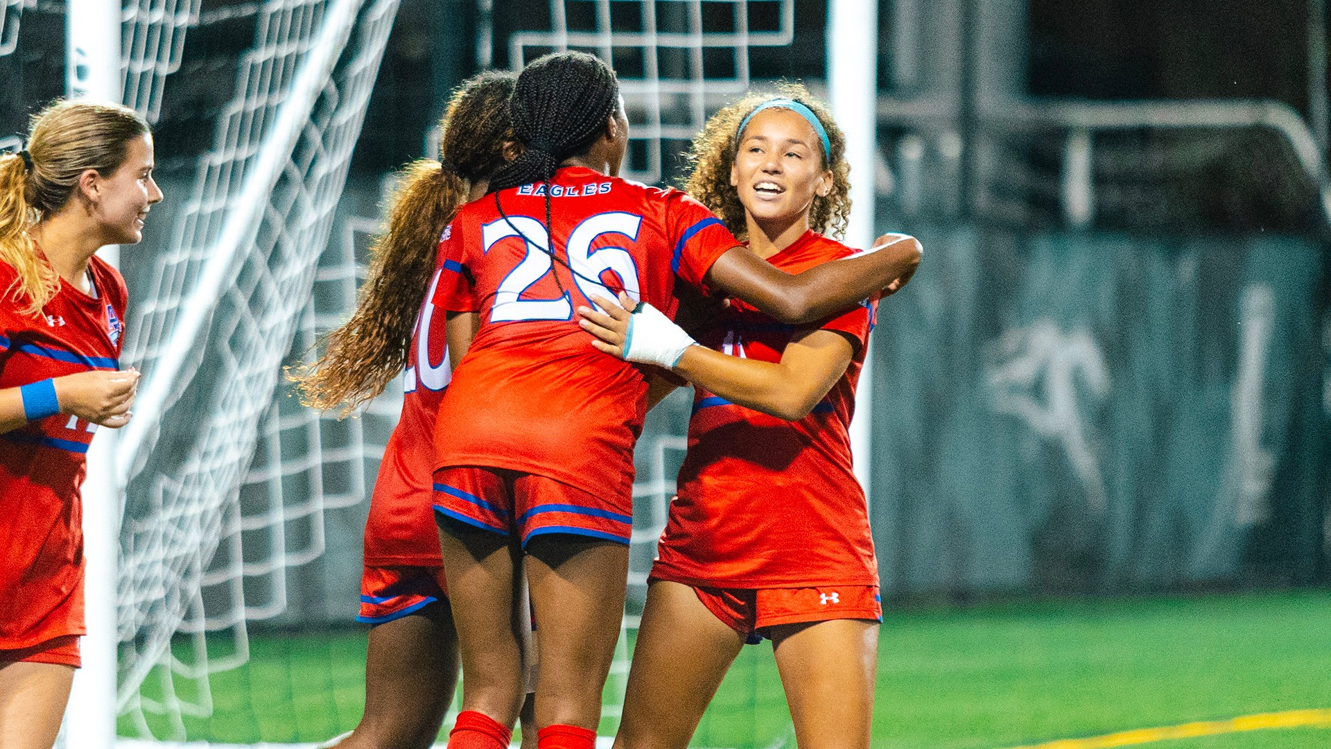 Natalia Croce and teammates celebrating a goal at Loyola Maryland in women's soccer