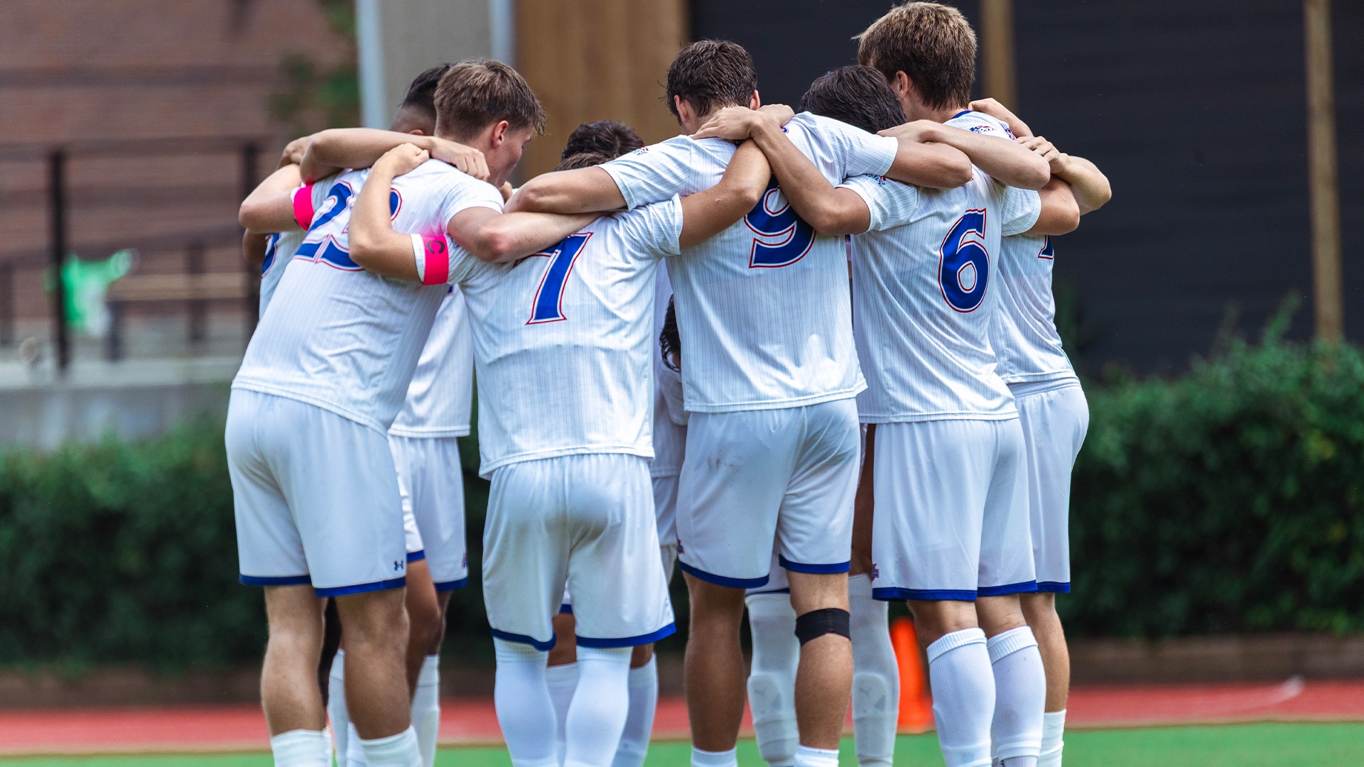 The men's soccer team in a huddle before a match against Rutgers. 