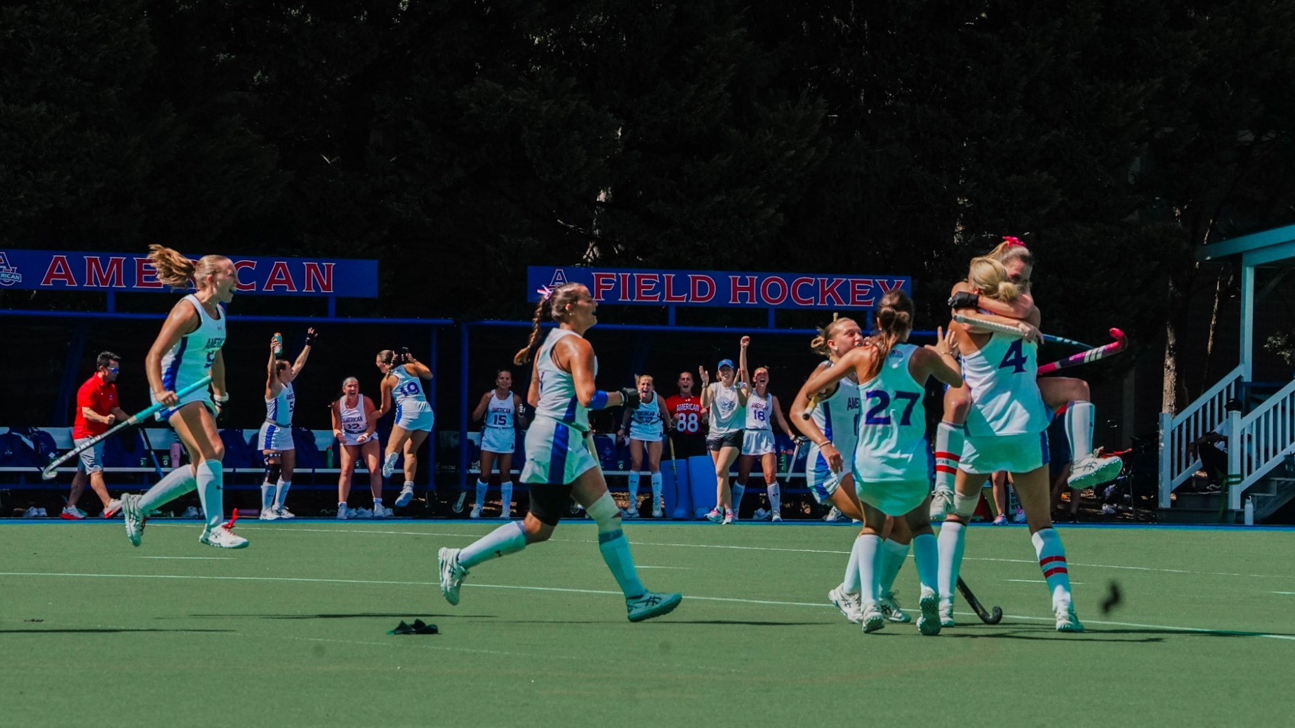 Field hockey celebrates a game winning goal on Jacobs Field.