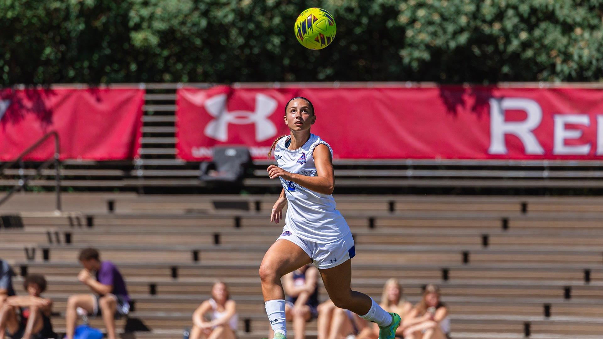 Julia Zeug looking up at the ball during a women's soccer game
