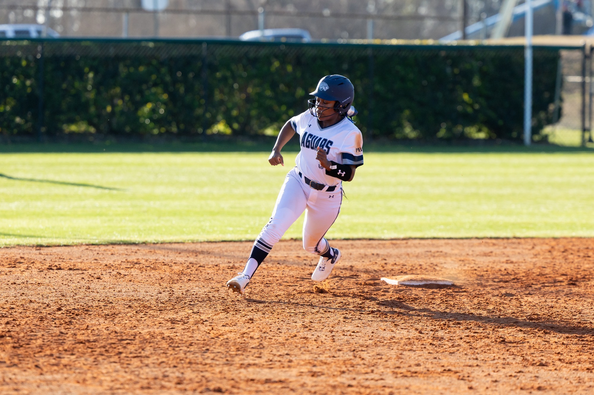 Ayelland Howard rounds second base during a softball game