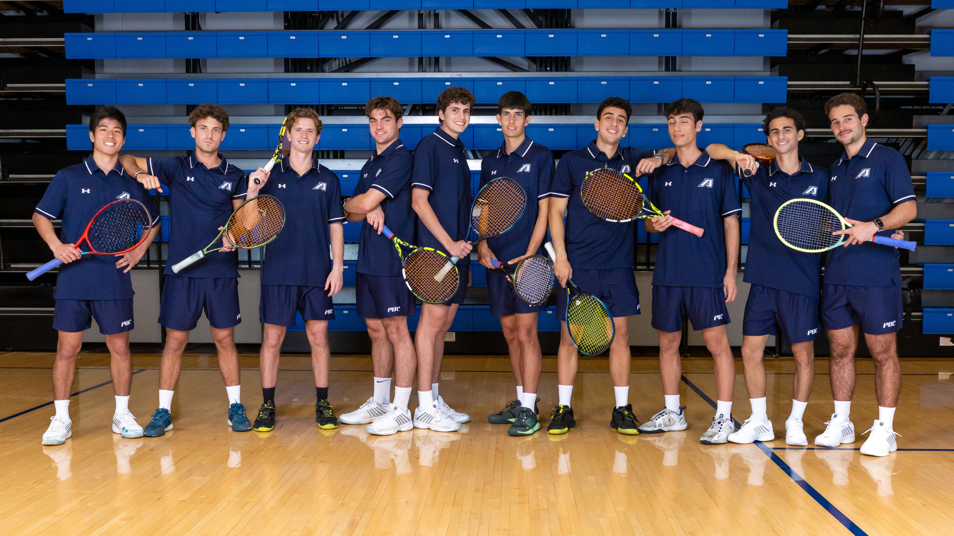 the 2025 mens tennis team posing for a photo in the gym