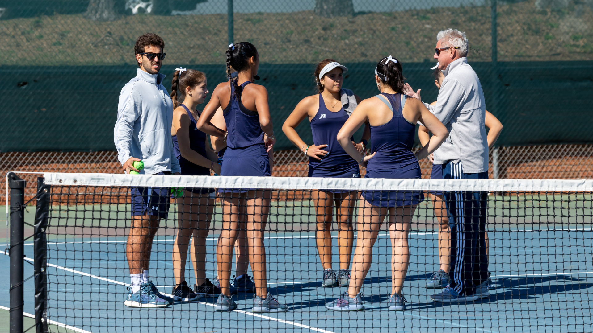 augusta tennis programs in a huddle