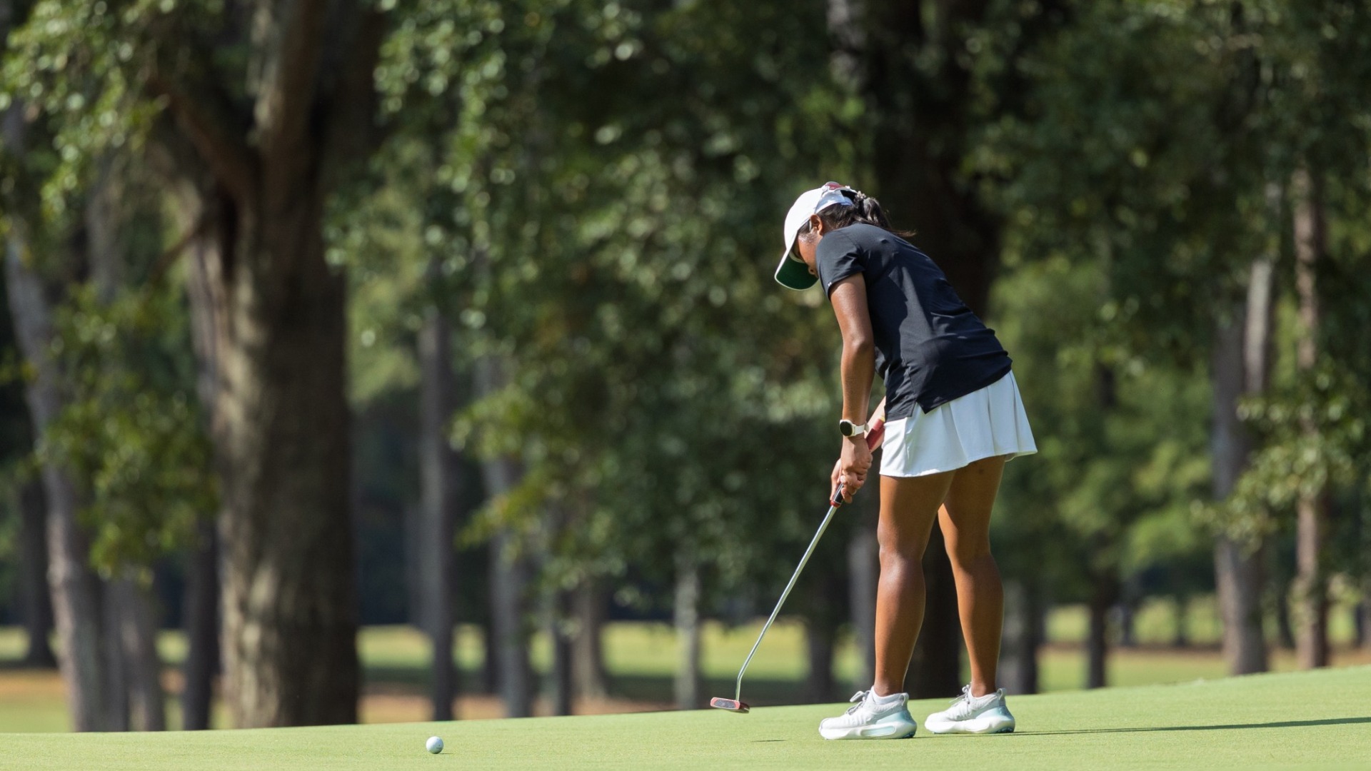 An Augusta women's golfer putts