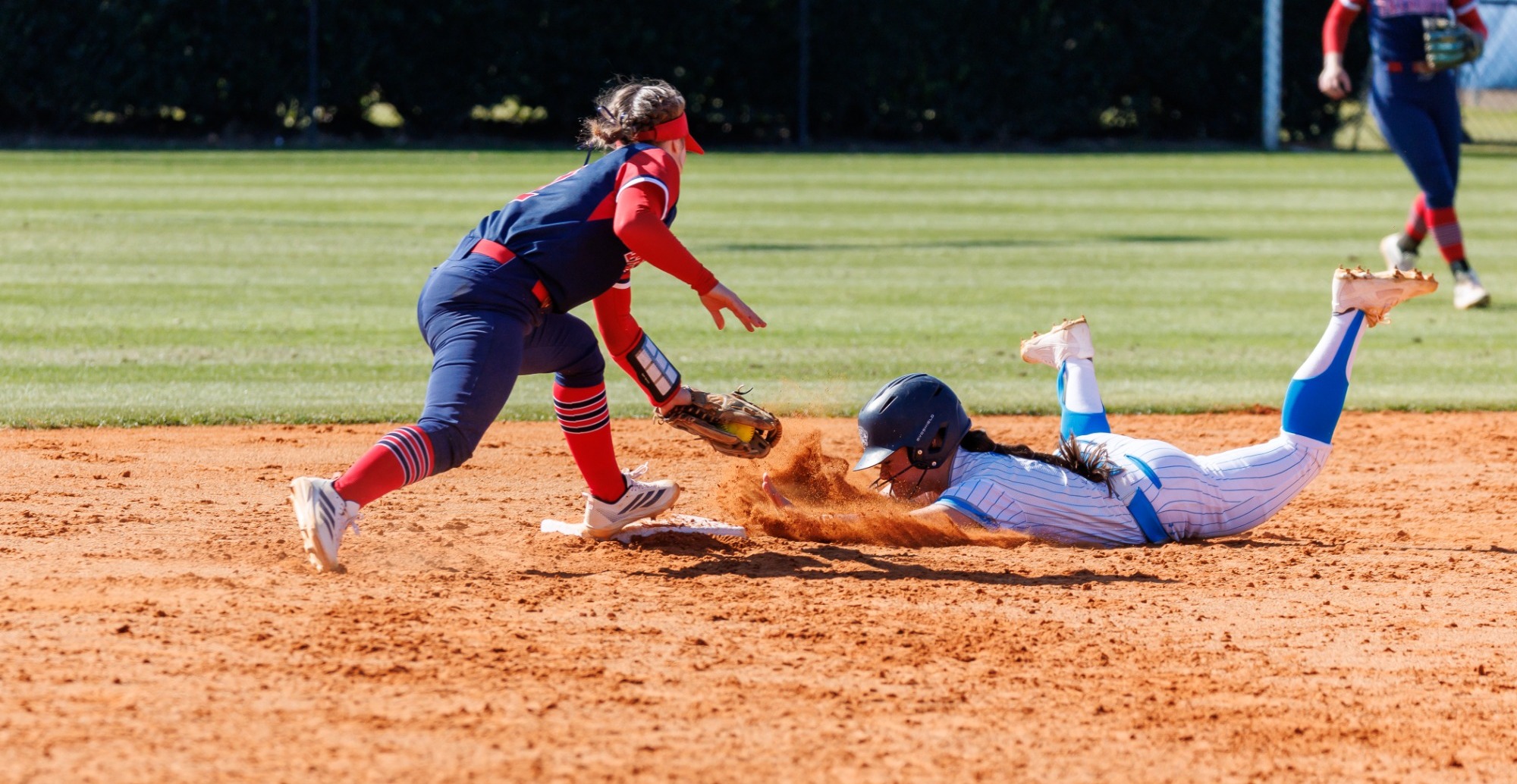softball player sliding into base