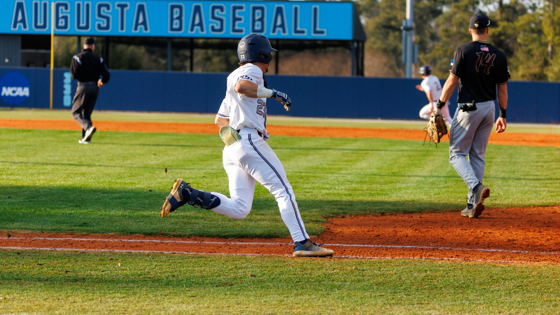 An Augusta base runner rounds first