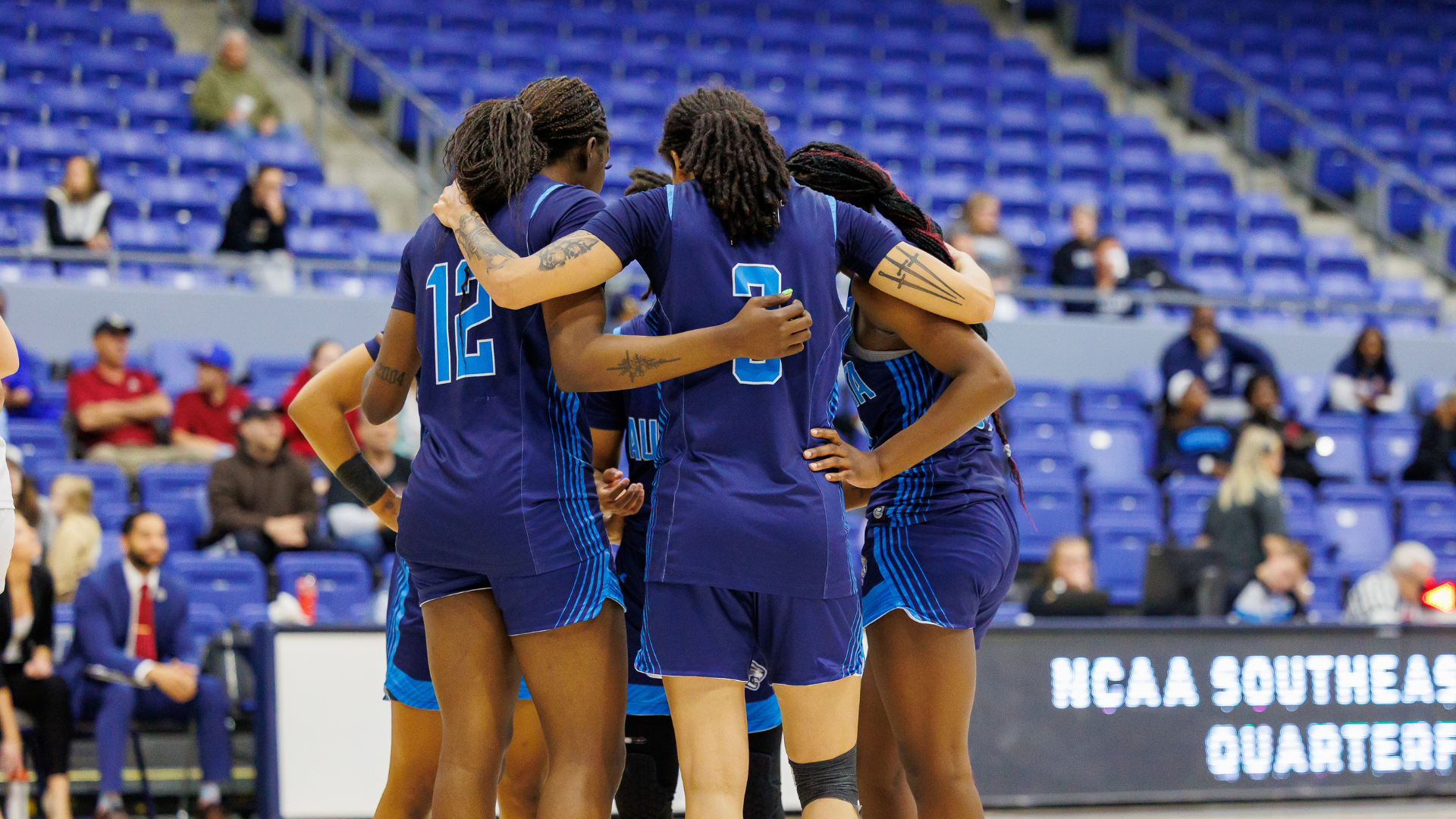 Augusta Women's Basketball in a huddle at the NCAA Tournament
