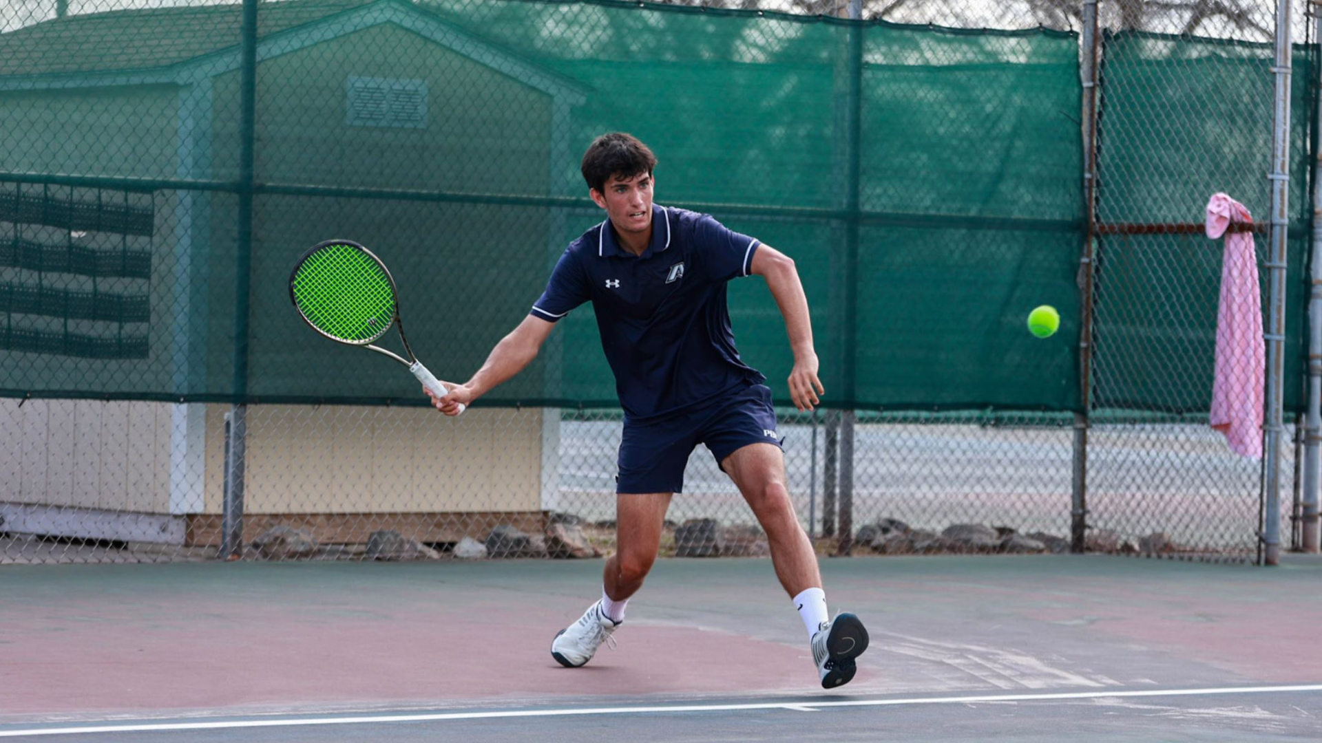 Humberto Pinto hitting a tennis ball at Newman Tennis Center