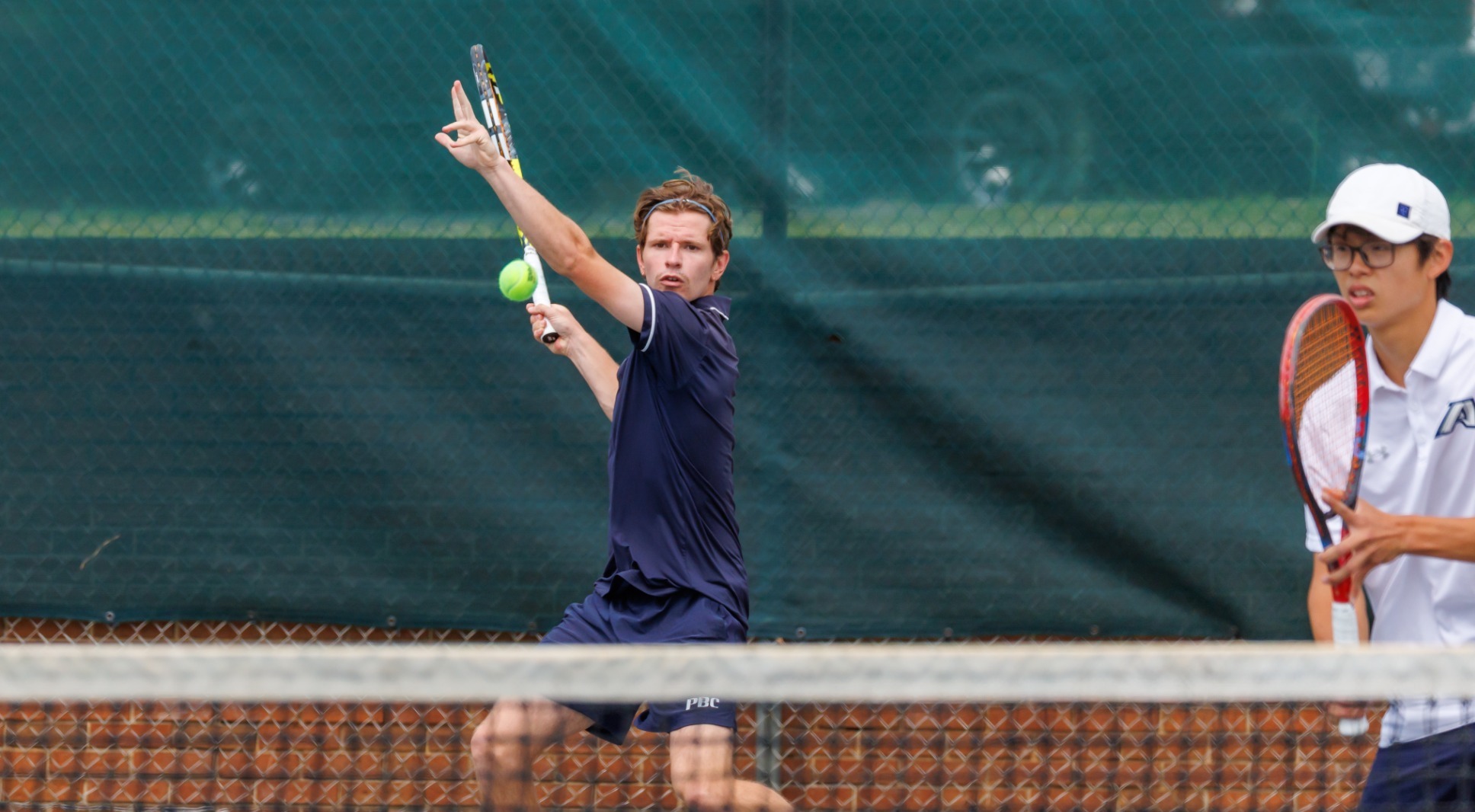 Arthur Valette swinging during doubles 