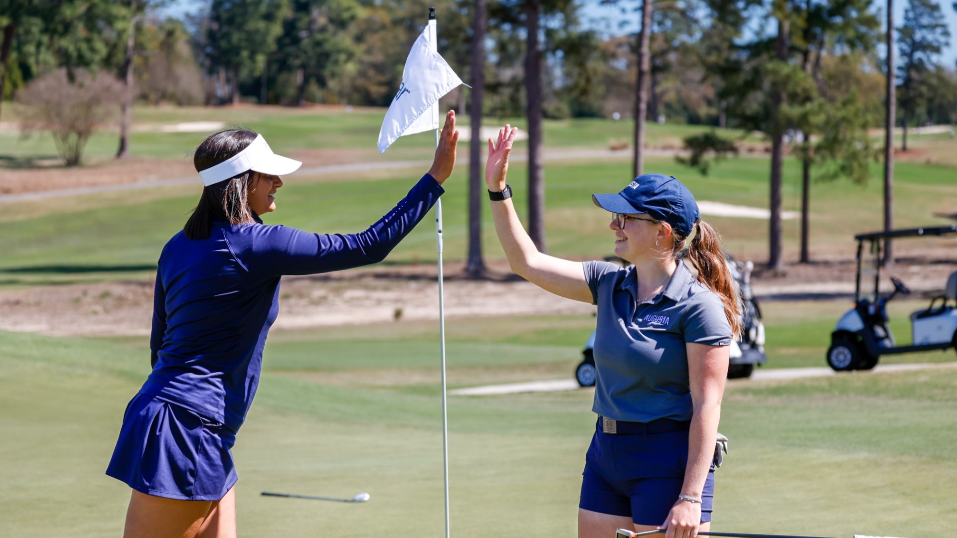 Marine Legentil and Sofia Valera give each other a high 5