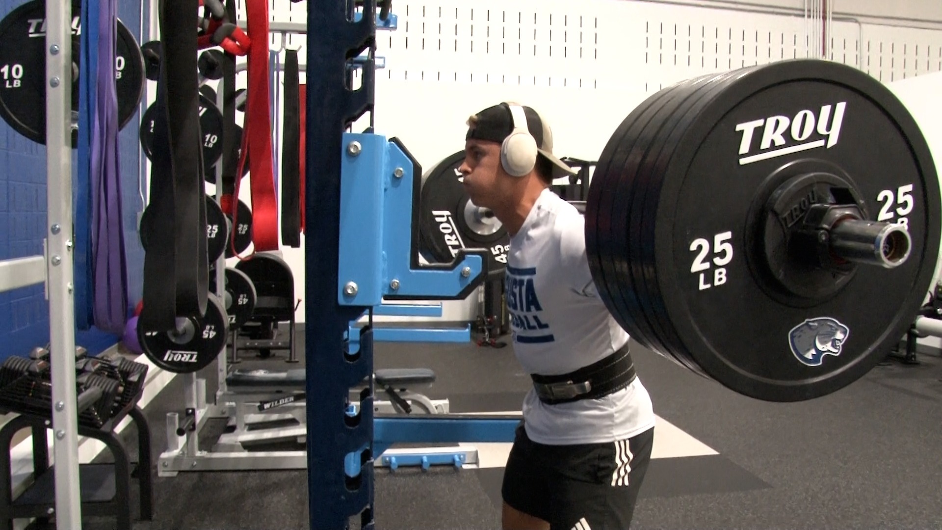 A baseball player lifts weights in the performance center