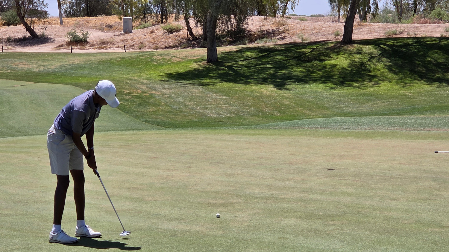 Josh Daniels hits a putt