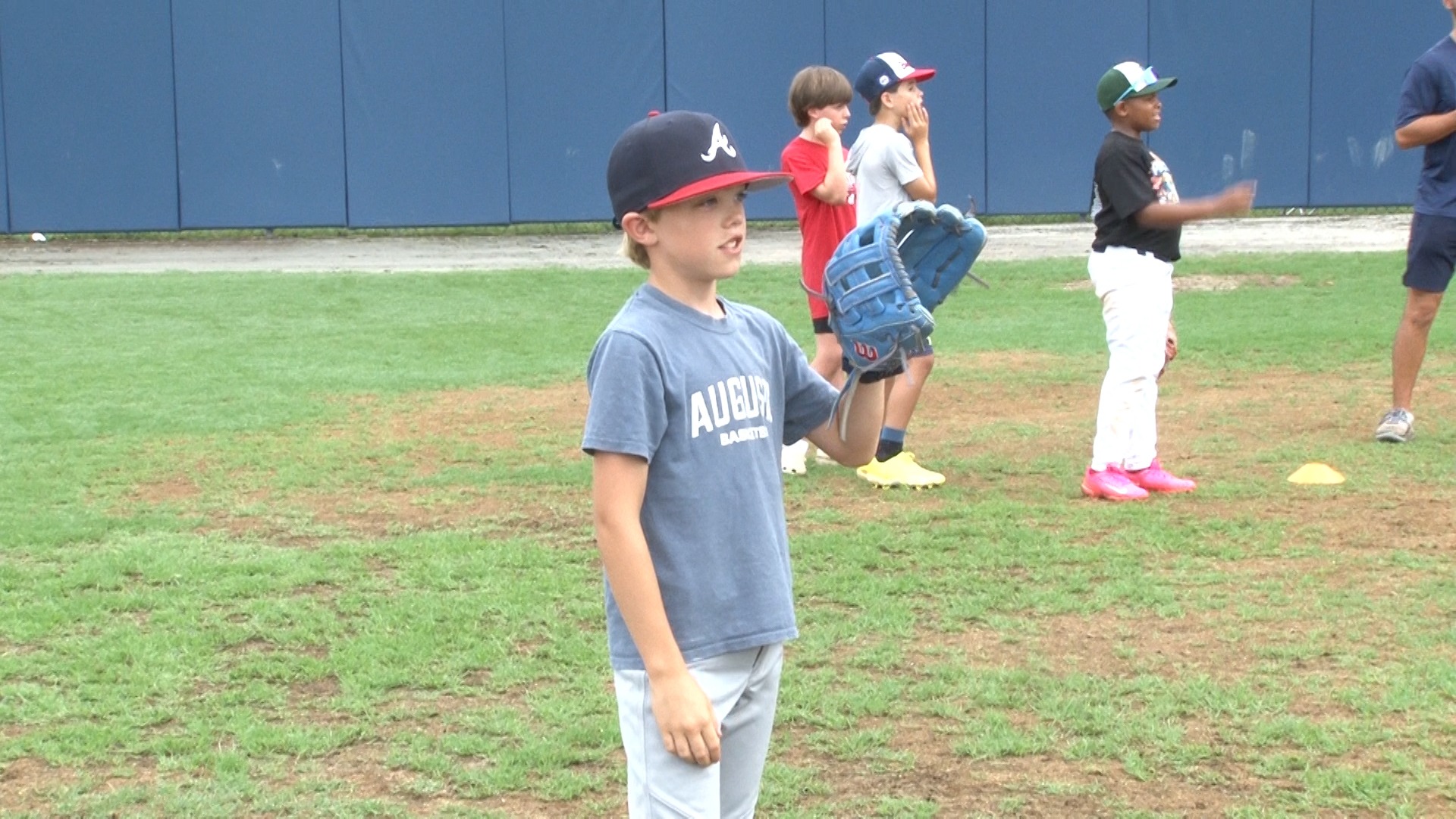 Augusta University baseball camp with a youngster 
