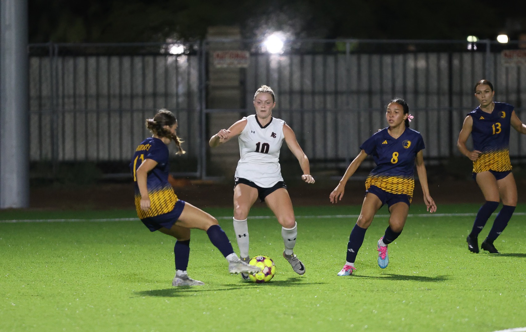 ACU's Krista Hardesty gets the ball from defender