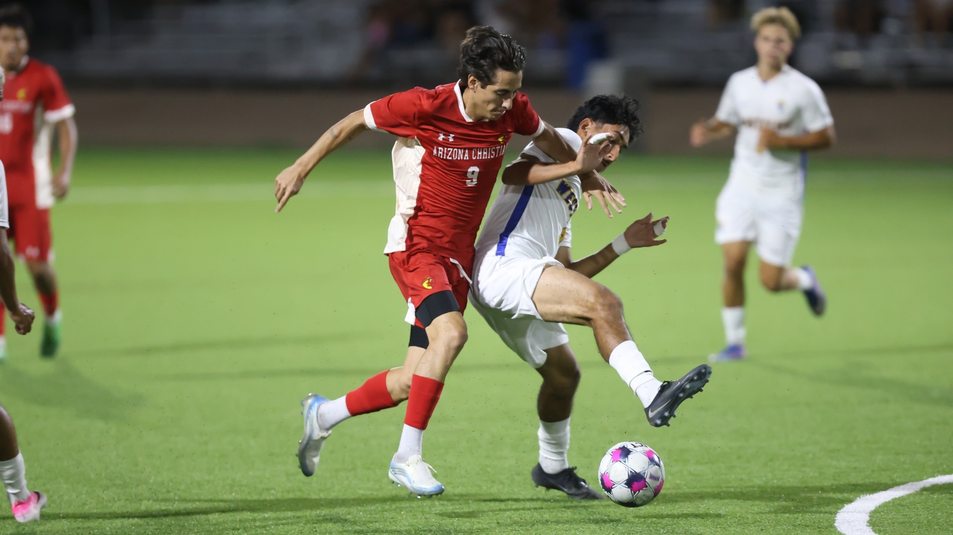 ACU's Raul Aranda dribbles ball with defender