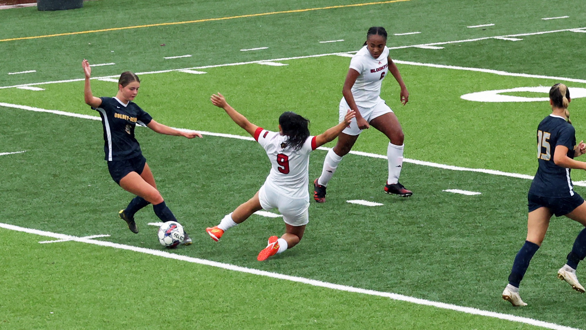 Women's Soccer player making a sliding tackle