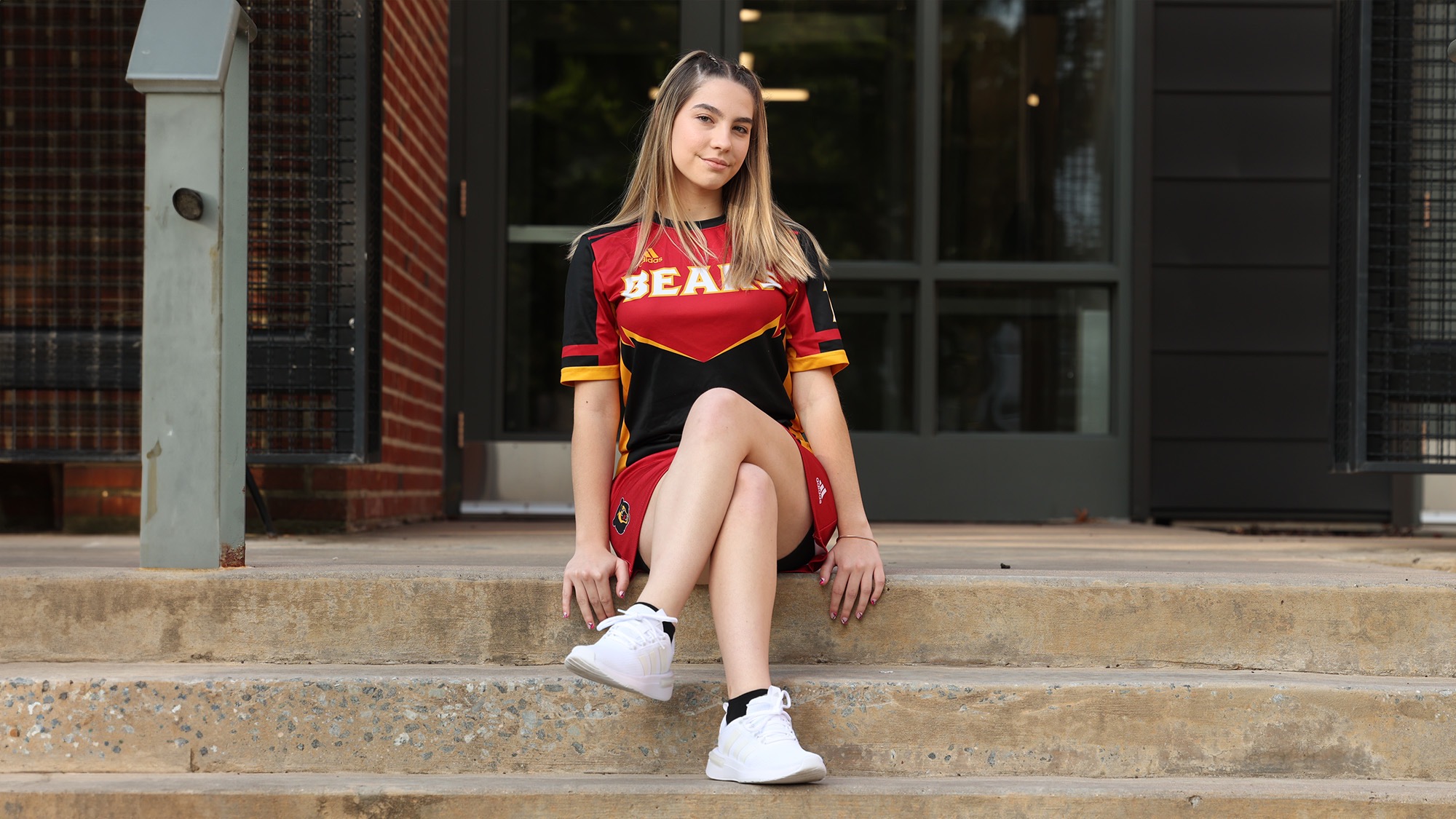 Alexa McManus of women's bowling team poses on the steps of the Creative Arts Building