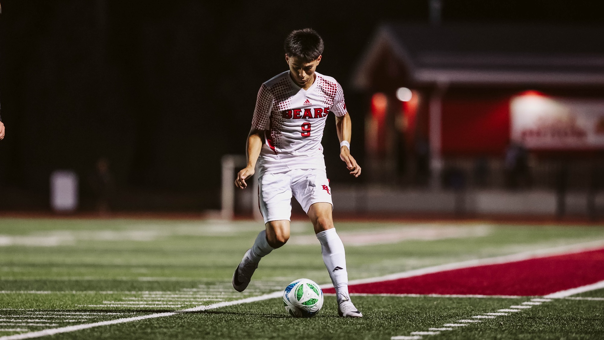 Freddy Vasquez dribbles the soccer ball on the field