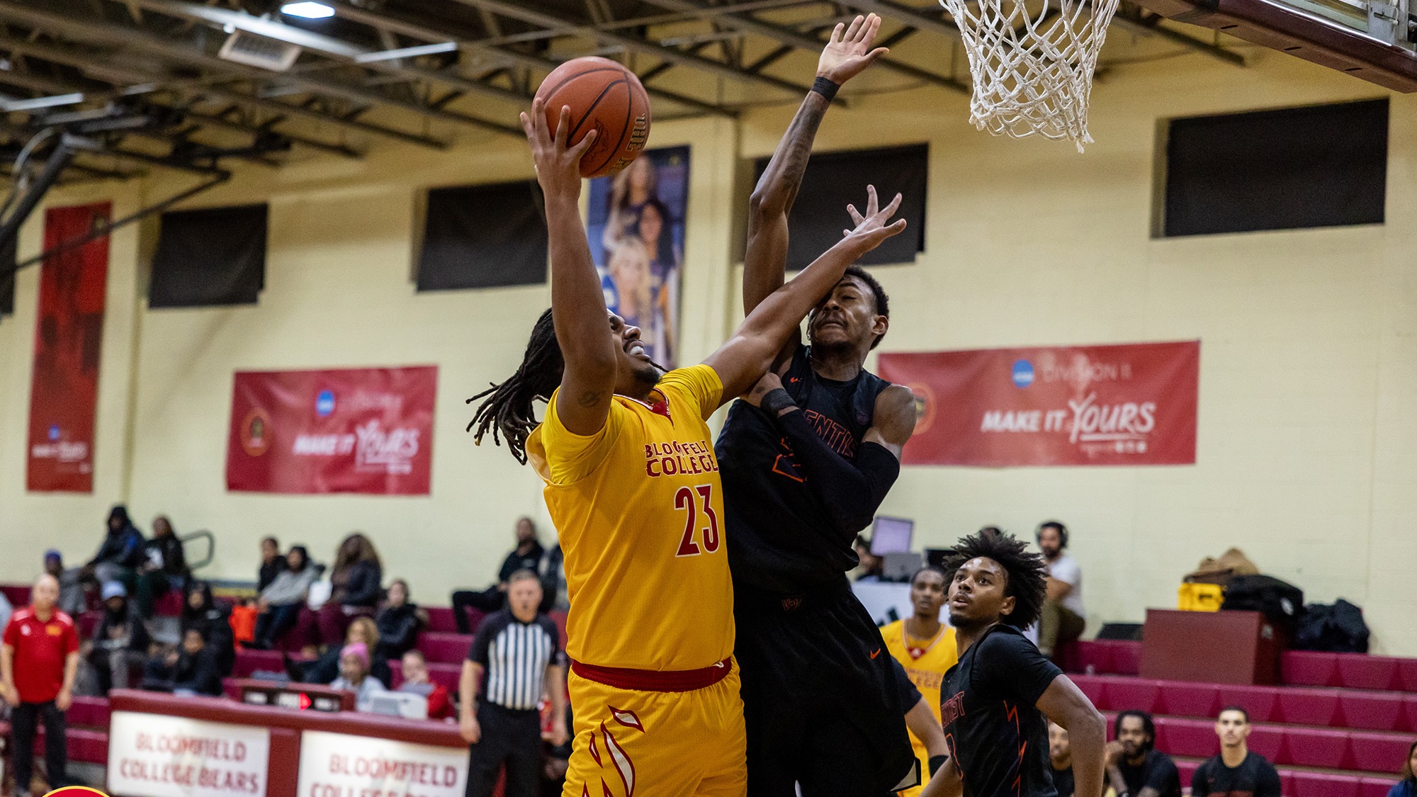 Marcus Bucknall holds off a defender while going for a layup