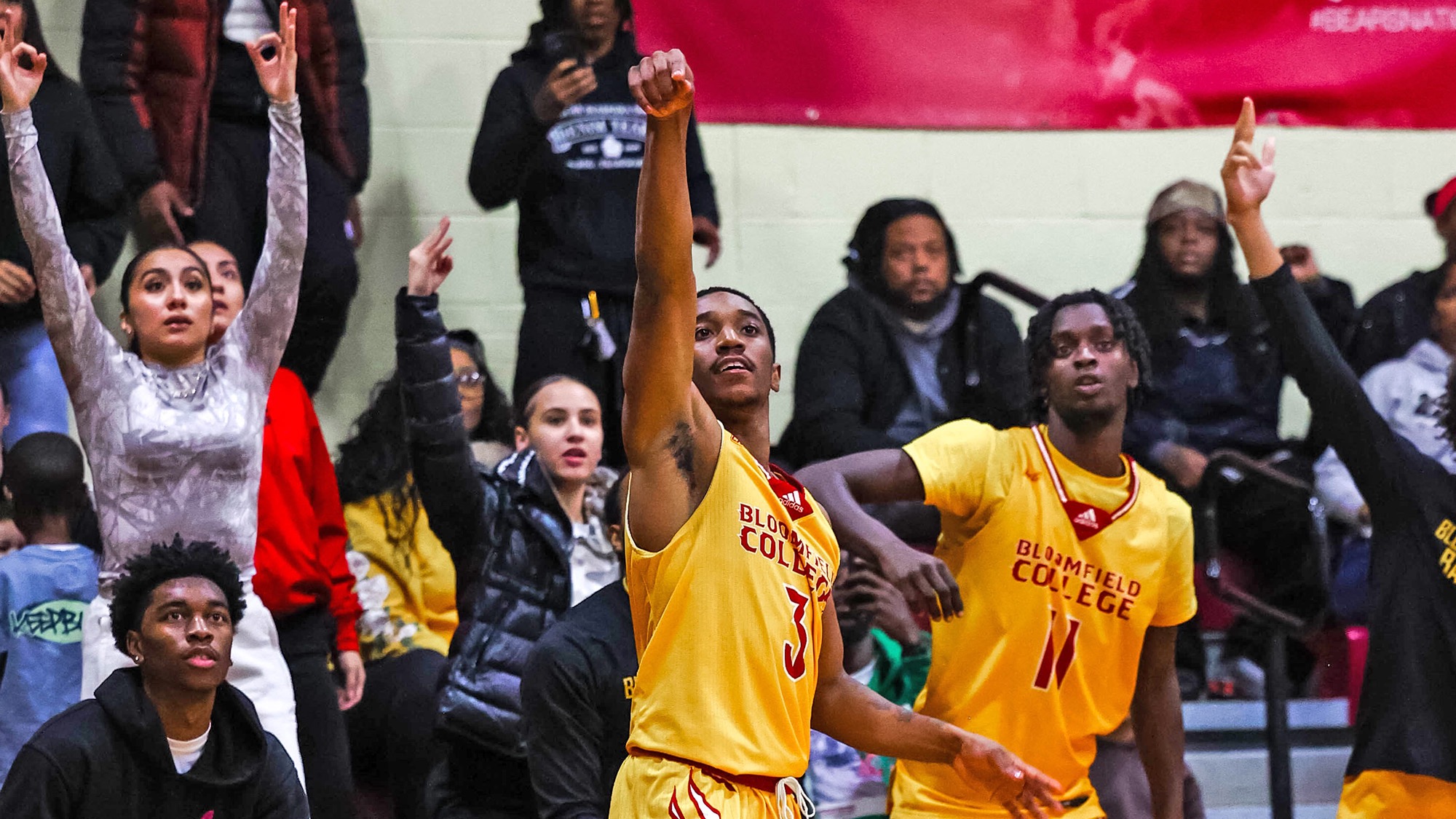 Semaj Bethea shoots a jumper with the crowd behind him