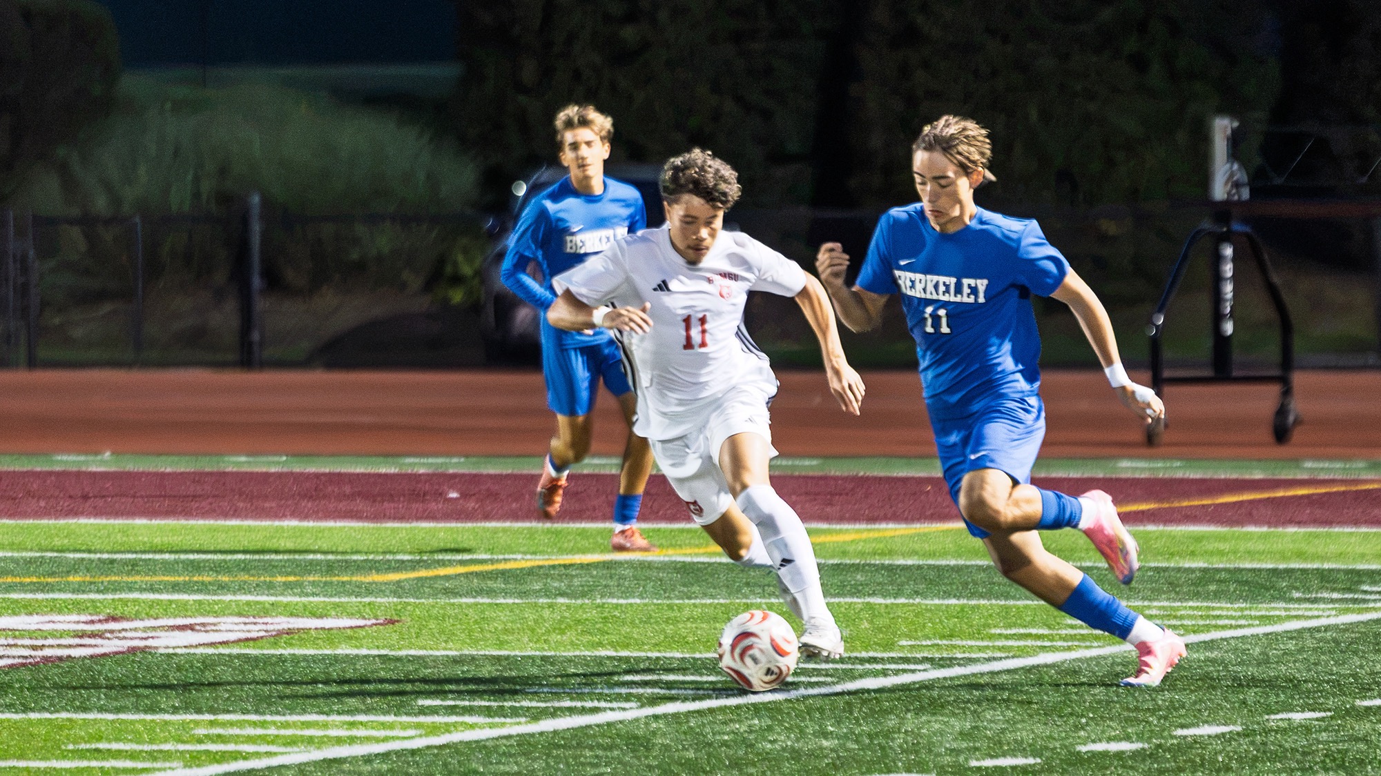 Men's Soccer defender runs stride for stride with Bekeley player at Foley Field