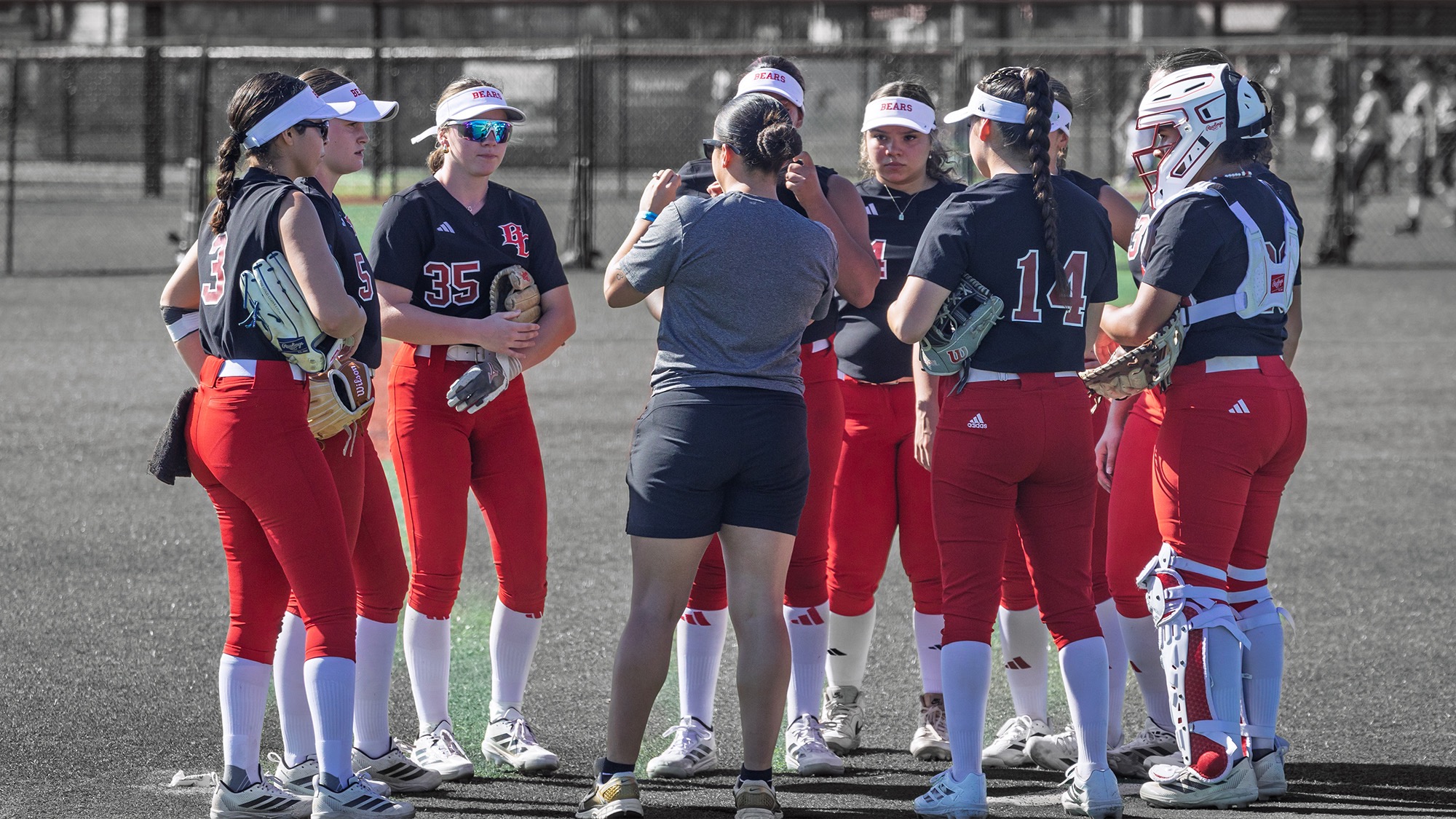 Softball team meeting in the pitching circle in Florida