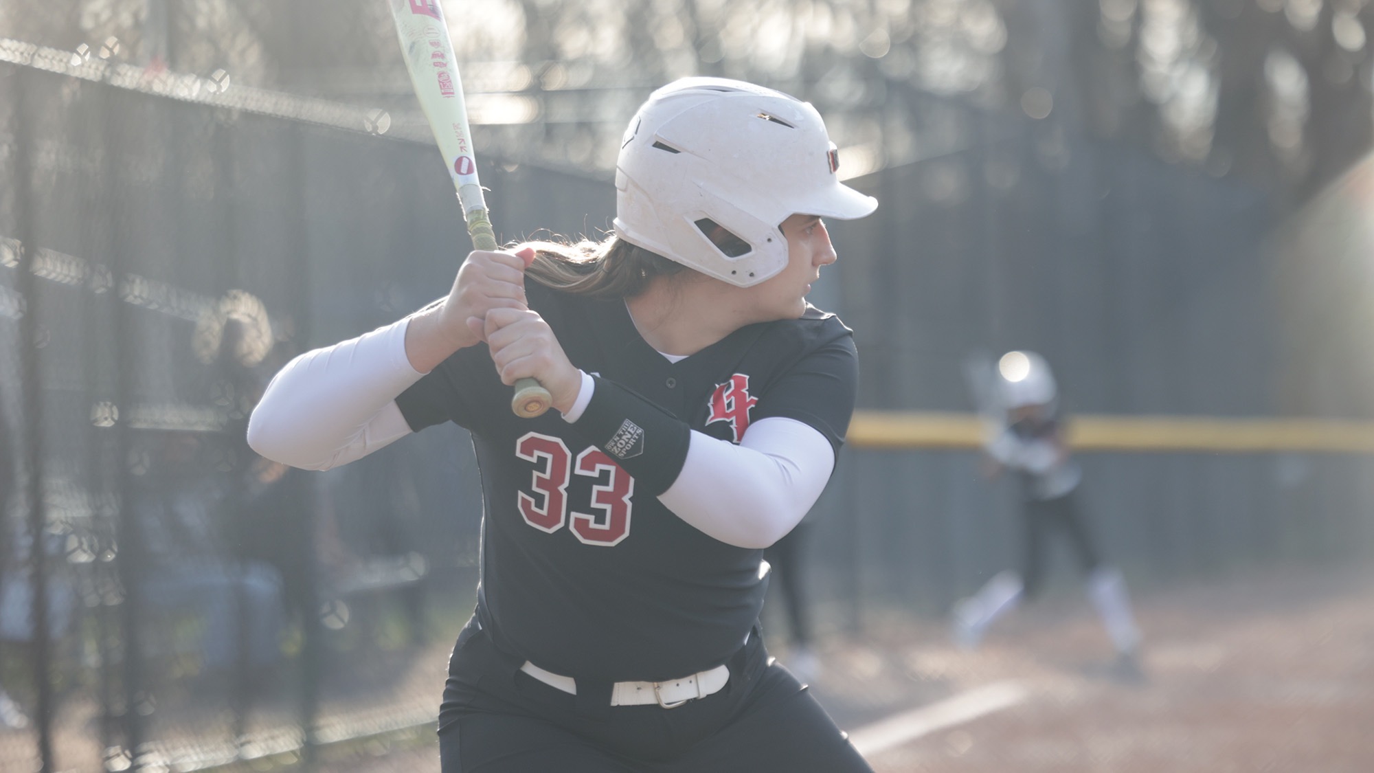 Kate ready to bat at the plate for softball