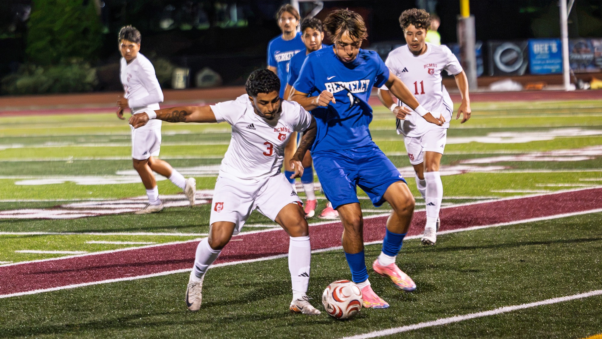 Daniel Tabares of men's soccer battles a Berkeley player for the ball
