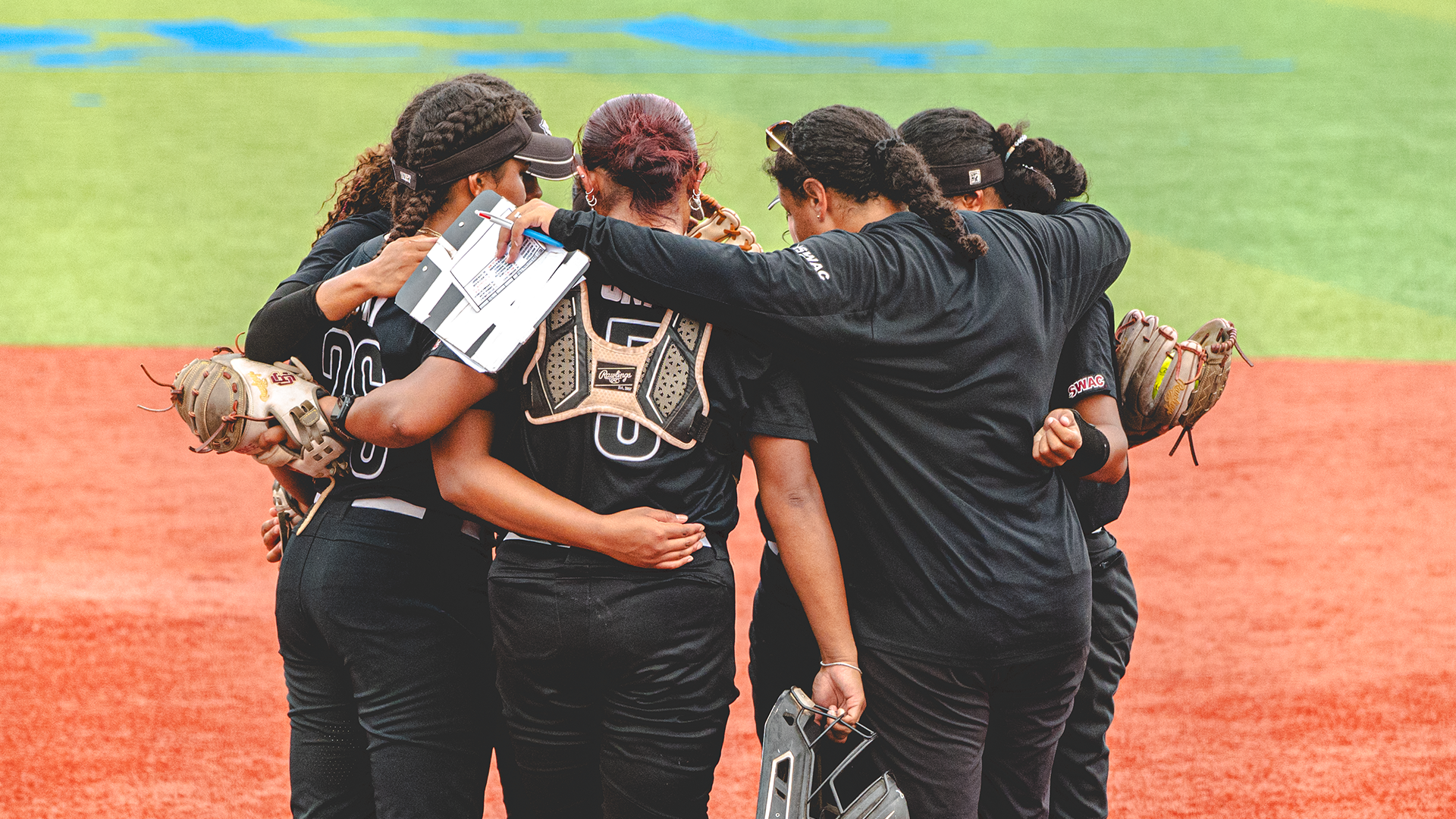 Softball team huddle at Southern SWAC Tournament