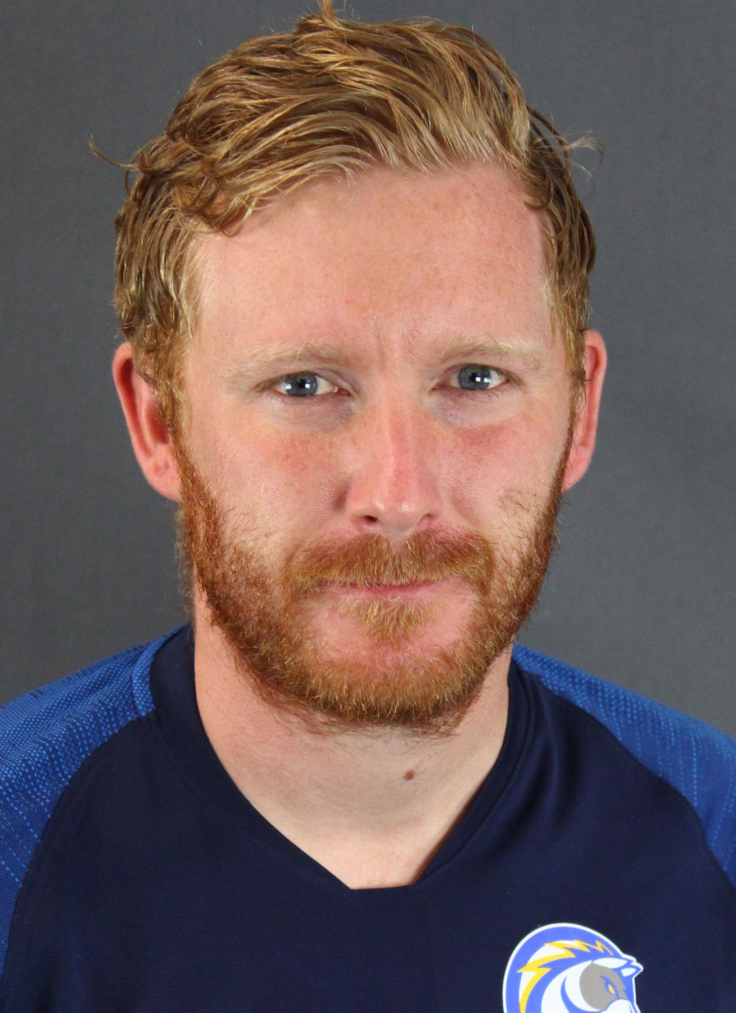 Coach Paul Cox headshot on gray background