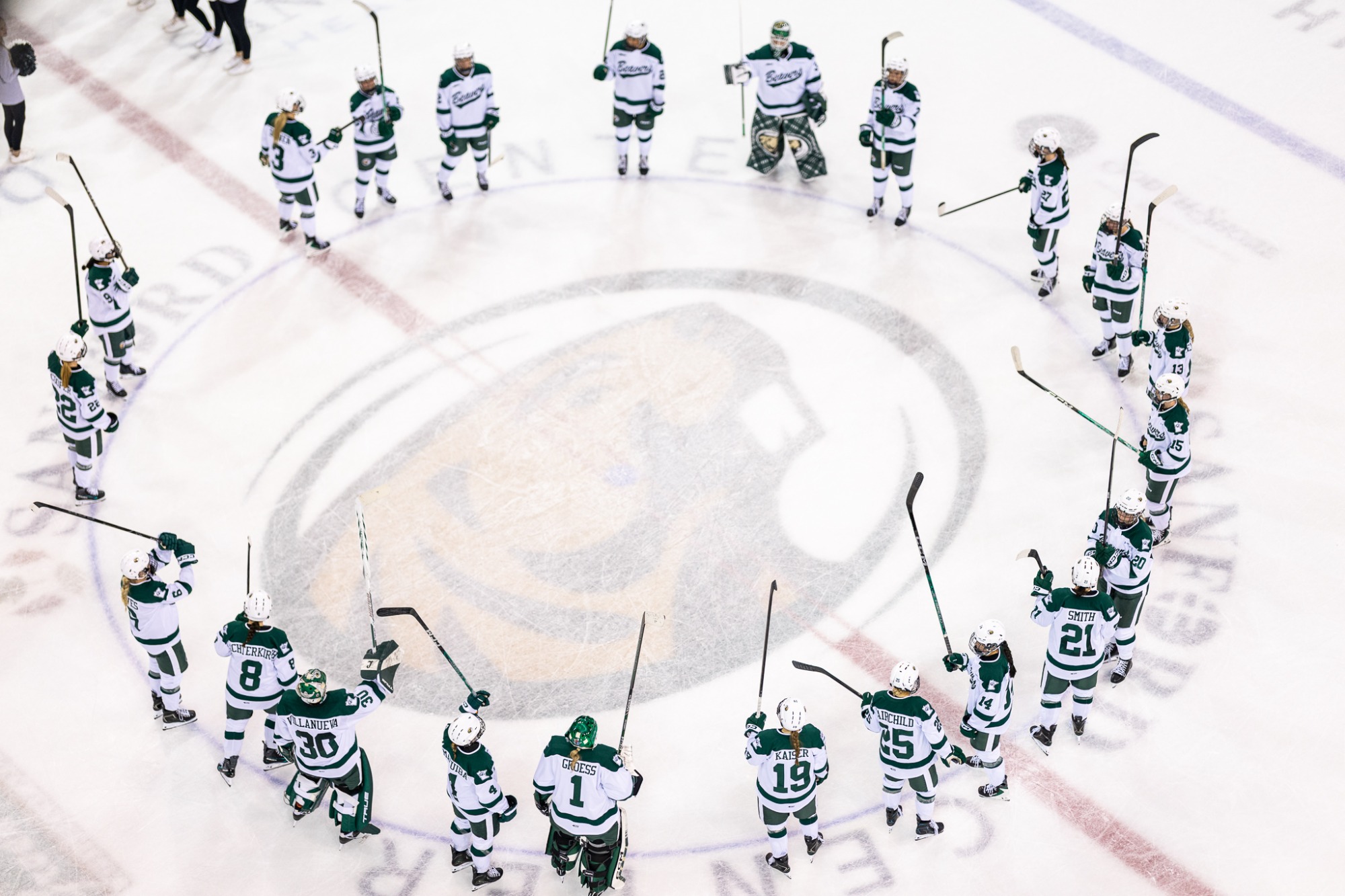 Overhead view of the Bemidji State team gathered in a circle at center ice following the game.