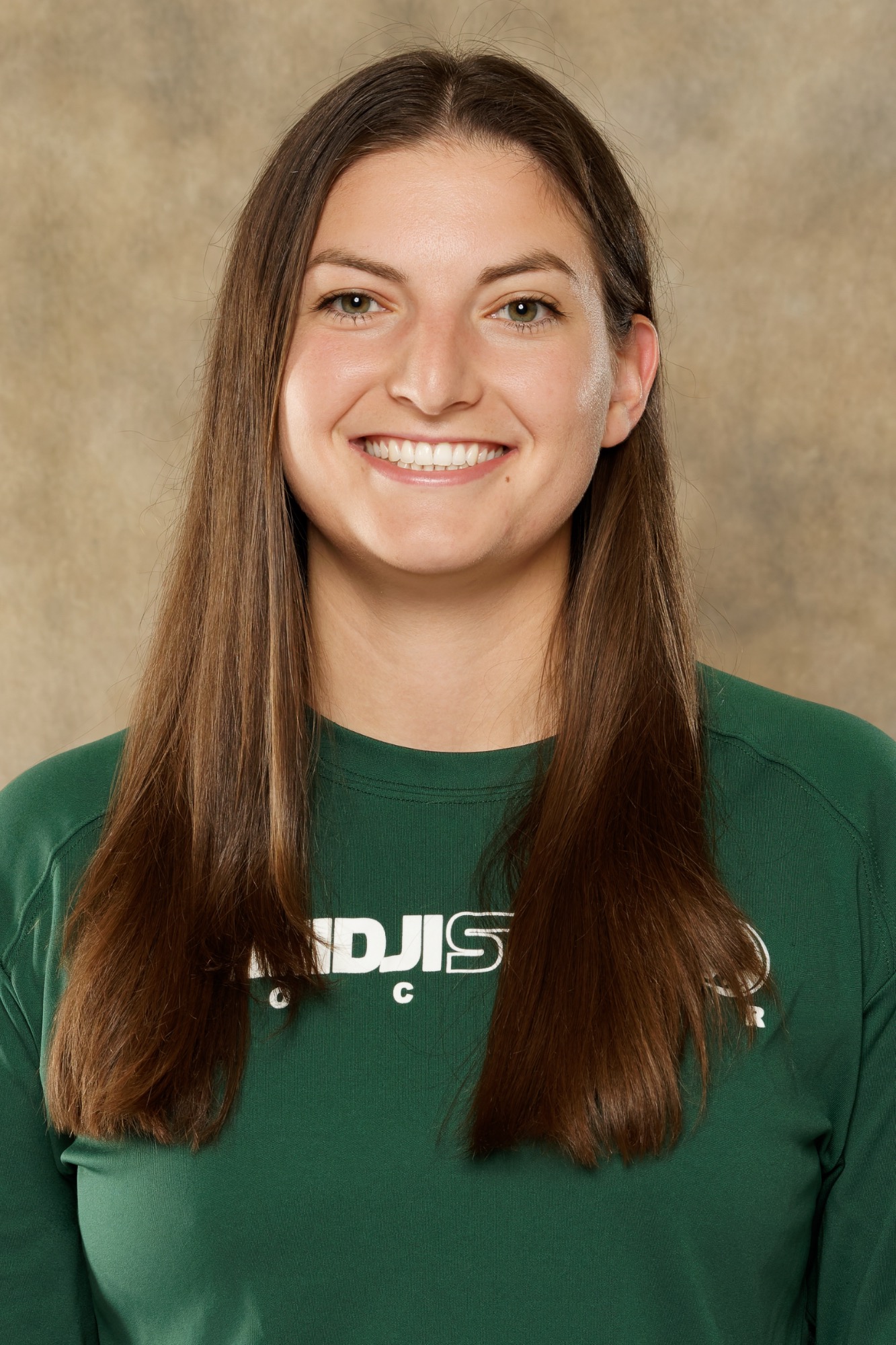 Portrait of Bemidji State soccer staff member with long straight dark brown hair wearing a green Bemidji State Soccer shirt