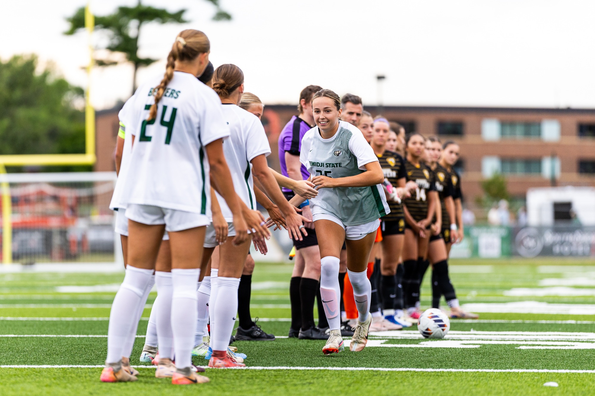 Molly Hagelie runs through the team line before the match.