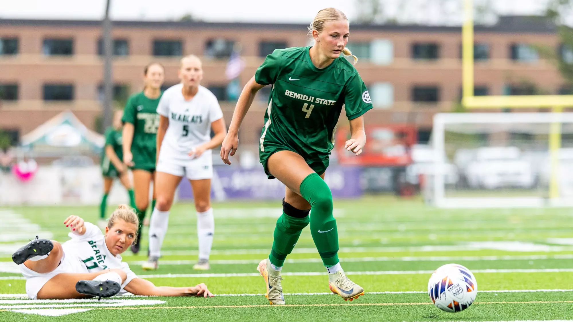 Meredith Paar continues toward the ball after a Northwest Missouri State defender's slide.