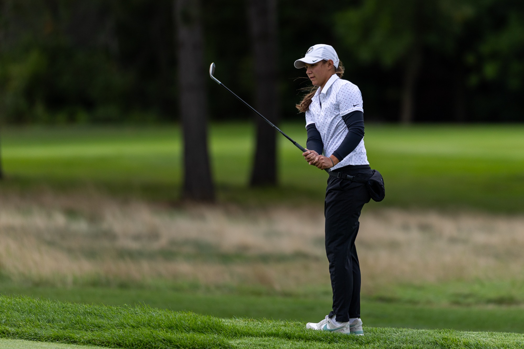 Sara Sroga watches the ball flight after a chip shot near the green.