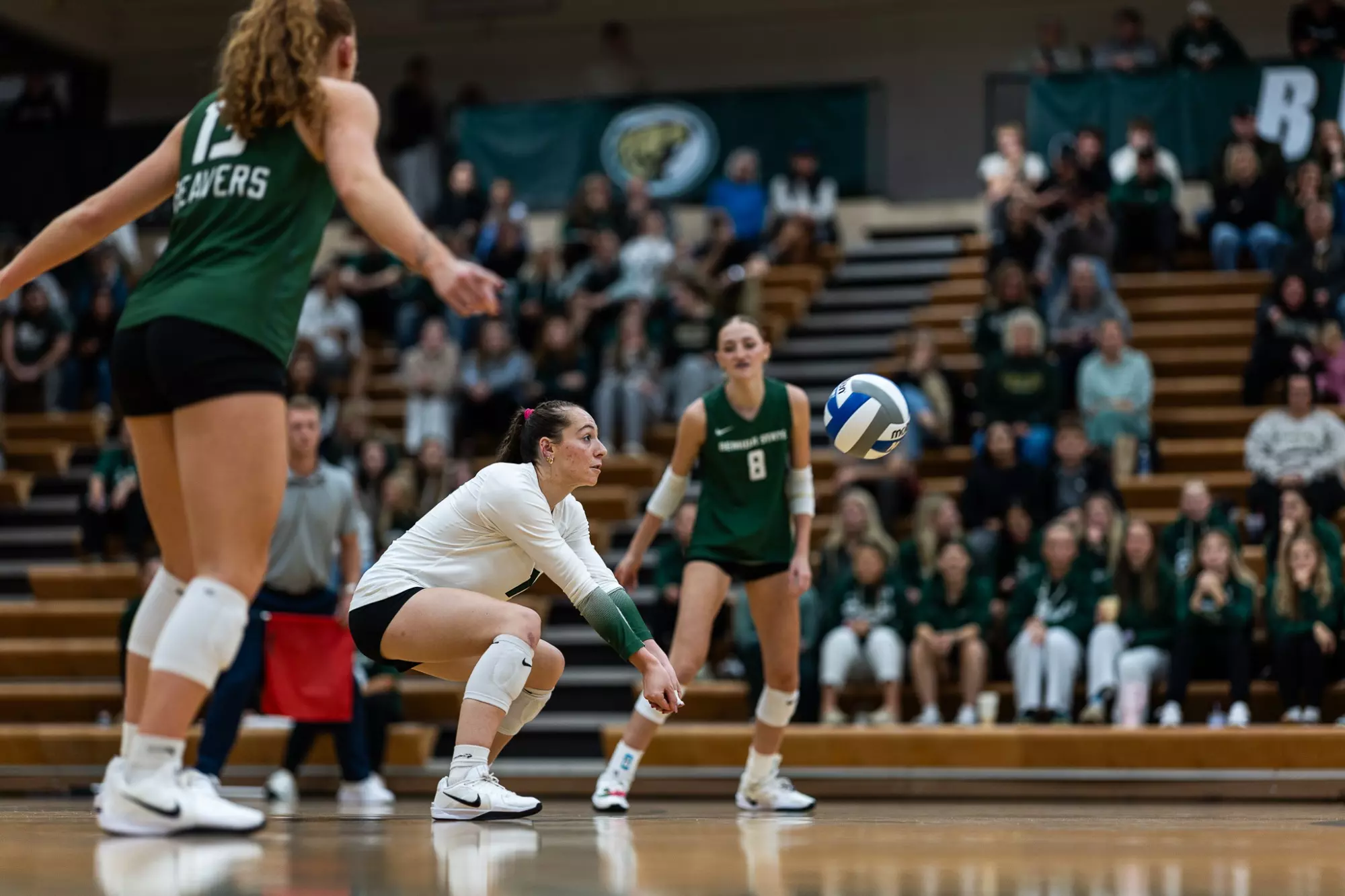 Ava Boelter (18) uses a forearm pass as teammates prepare for the next contact.